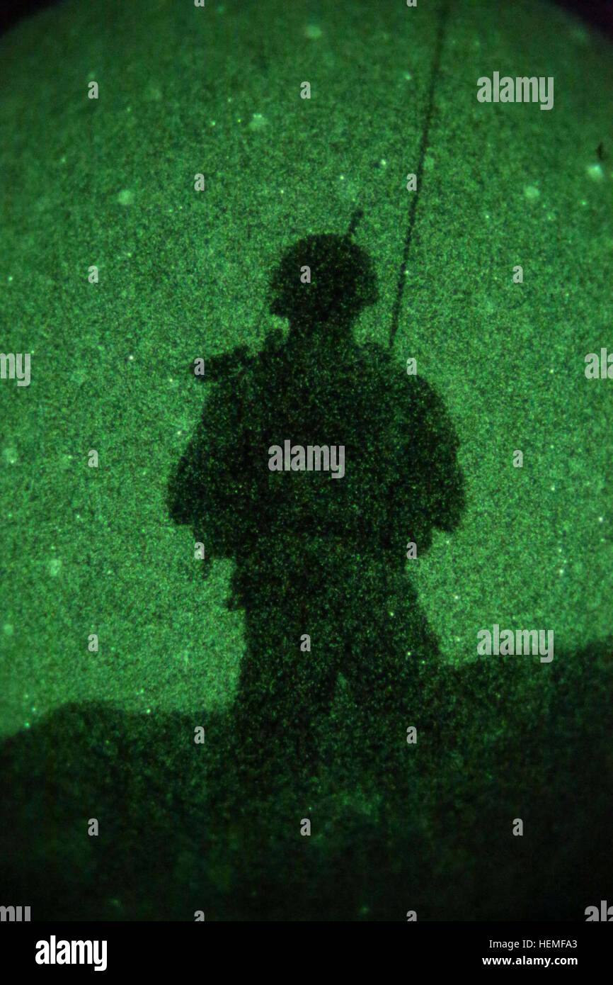 A coalition force member observes the area during an Afghan National ...