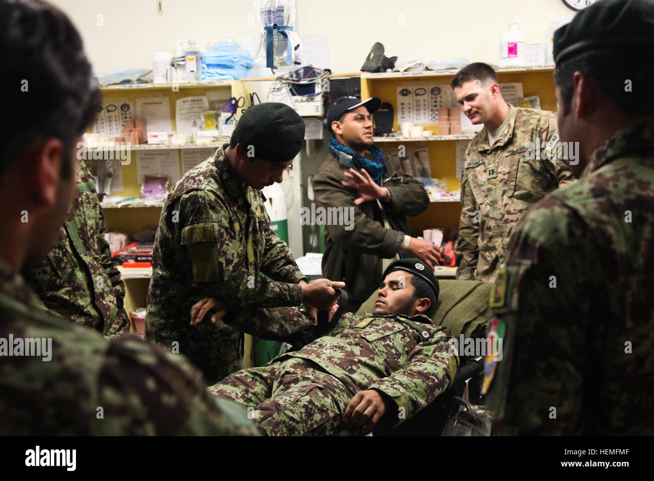 An Afghan National Army soldier assigned to the 2nd Brigade, 201st Corps teaches fellow combat medics how to apply a tourniquet to an upper extremity during ANA medical training at Forward Operating Base Joyce, Kunar province, Afghanistan, March 18, 2013. Medical training is held for ANA combat medics so they can teach combat lifesaver courses more efficiently to ANA soldiers. (U.S. Army photo by Spc. Ryan Hallgarth/Released) ANA medical training at FOB Joyce 130318-A-BX842-010 Stock Photo