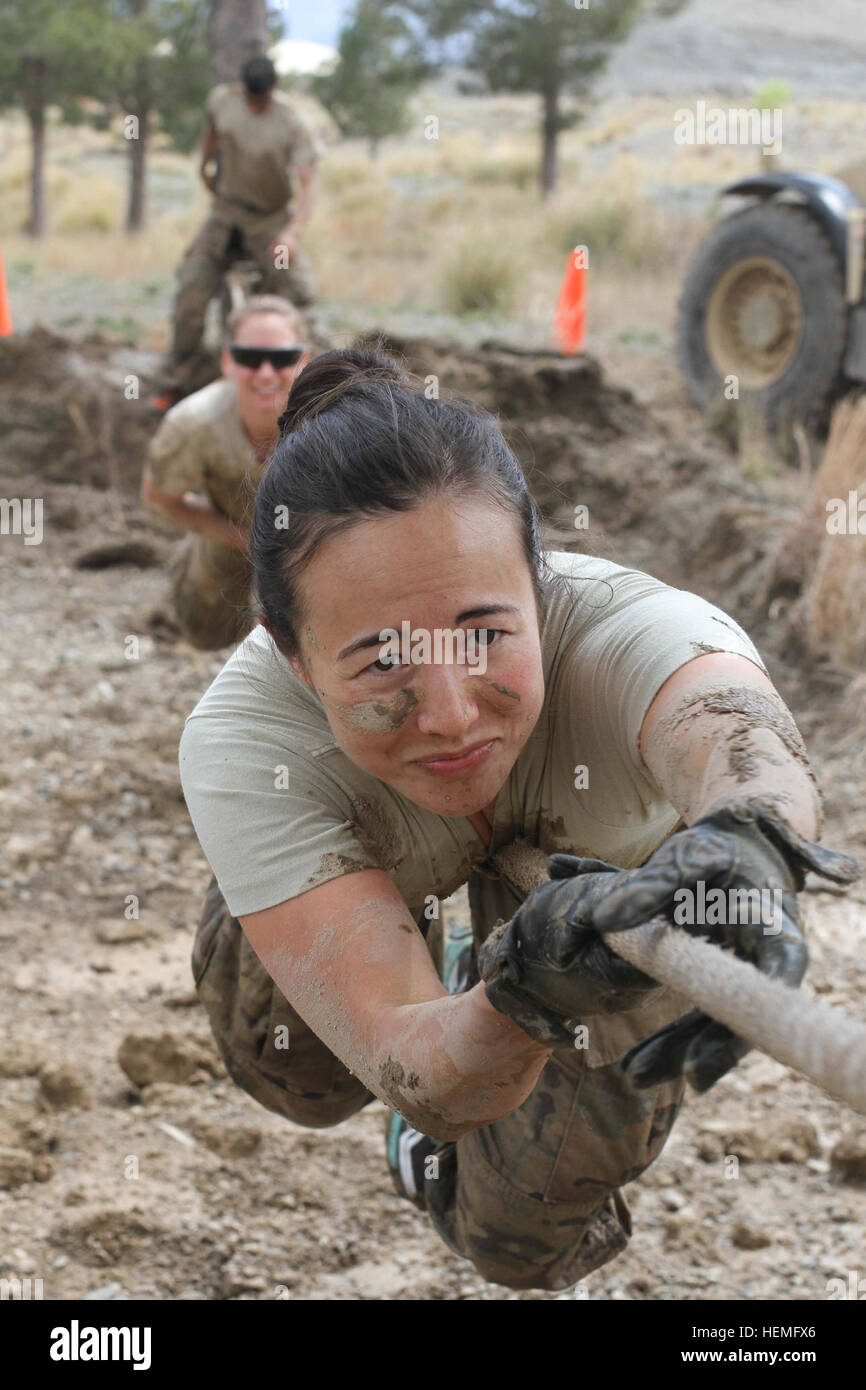 U.S. Soldiers slide across a 30-foot rope obstacle during a Mud Run at Forward Operating Base Salerno in Khost province, Afghanistan, March 24, 2013. More than 50 Soldiers assigned to various units from the forward operating base participated in the course. The two-mile course featured 15 different obstacles that challenged the Soldiers physically and mentally, while adding the elements of water and mud to help make the course even more difficult. (U.S. Army photo by Sgt. 1st Class Abram Pinnington/Released) Gettin%%%%%%%%E2%%%%%%%%80%%%%%%%%99 dirty, FOB Salerno hosts Mud Run 130324-A-AY560-8 Stock Photo