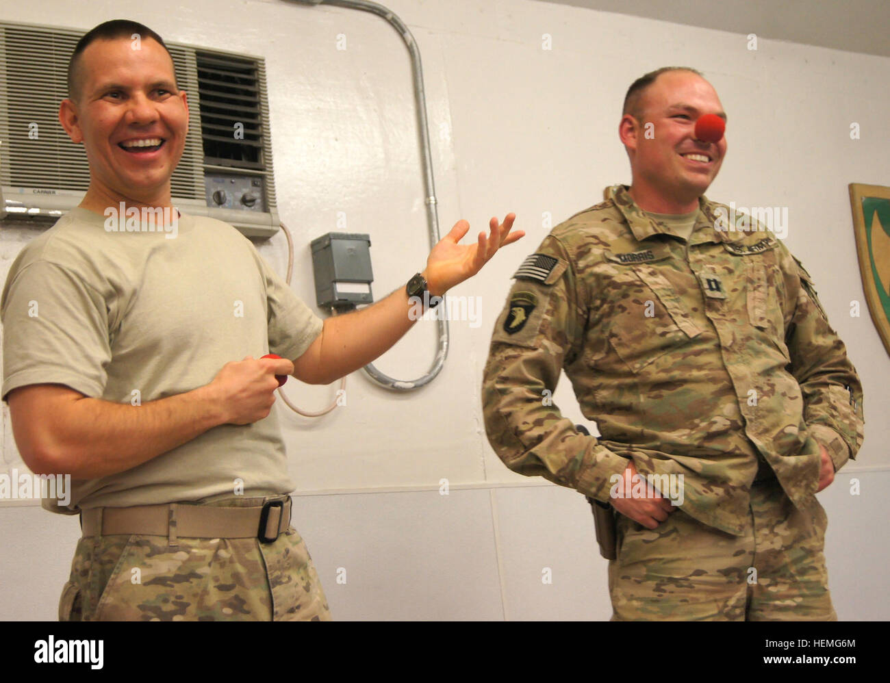U.S. Army Capt. John Morris plays along with a joke by Maj. Bruce Townley, a native of Chamois, Mo., at Forward Operating Base Lightning March 31, 2013. Morris and Townley are advisers to the Afghan National Army's 203rd 'Thunder' Corps in the Paktya province of Afghanistan. Townley, an alumnus of Ringling Brothers and Barnum & Bailey Clown College, performed an Easter Sunday magic and juggling show for the soldiers of FOB Lightning. (U.S. Army photo by Spc. Ryan Scott, 129th Mobile Public Affairs Detachment/RELEASED) Army major clowns around at FOB Lightning 130331-A-HL120-002 Stock Photo
