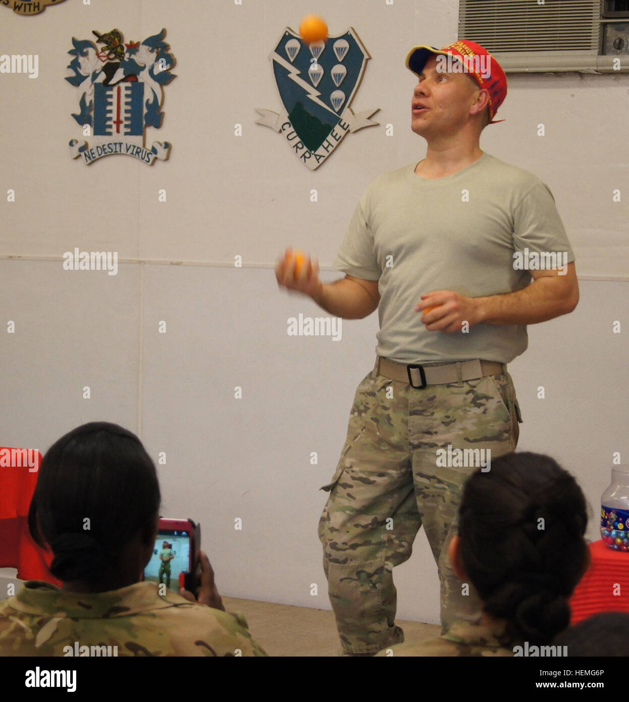 U.S. Army Maj. Bruce Townley, a native of Chamois Mo., juggles oranges during an Easter Sunday magic and juggling show at Forward Operating Base Lightning, March 31, 2013. Tyson and Townley are advisers to the Afghan National Army's 203rd 'Thunder' Corps in the Paktya province of Afghanistan. Townley, an alumnus of Ringling Brothers and Barnum & Bailey Clown College, performed for a nearly-full house in the FOB's dining facility. (U.S. Army photo by Spc. Ryan Scott, 129th Mobile Public Affairs Detachment/RELEASED) Army major clowns around at FOB Lightning 130331-A-HL120-003 Stock Photo