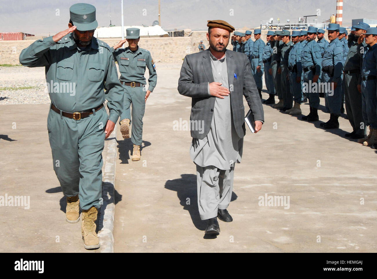 Lt. Col. Del Agha (left), Police Training Center commander, and Provincial Deputy Governor Sher Pacha make a pass in front of a formation at the Police Training Center in Tarin Kot, Afghanistan, April 4, 2013. The PTC graduated its final class in Uruzgan Province, which consisted of 161 police officers. (U.S. Army photo by Sgt. Jessi Ann McCormick) Police Training Center graduates final class in Uruzgan 130403-A-FS372-062 Stock Photo