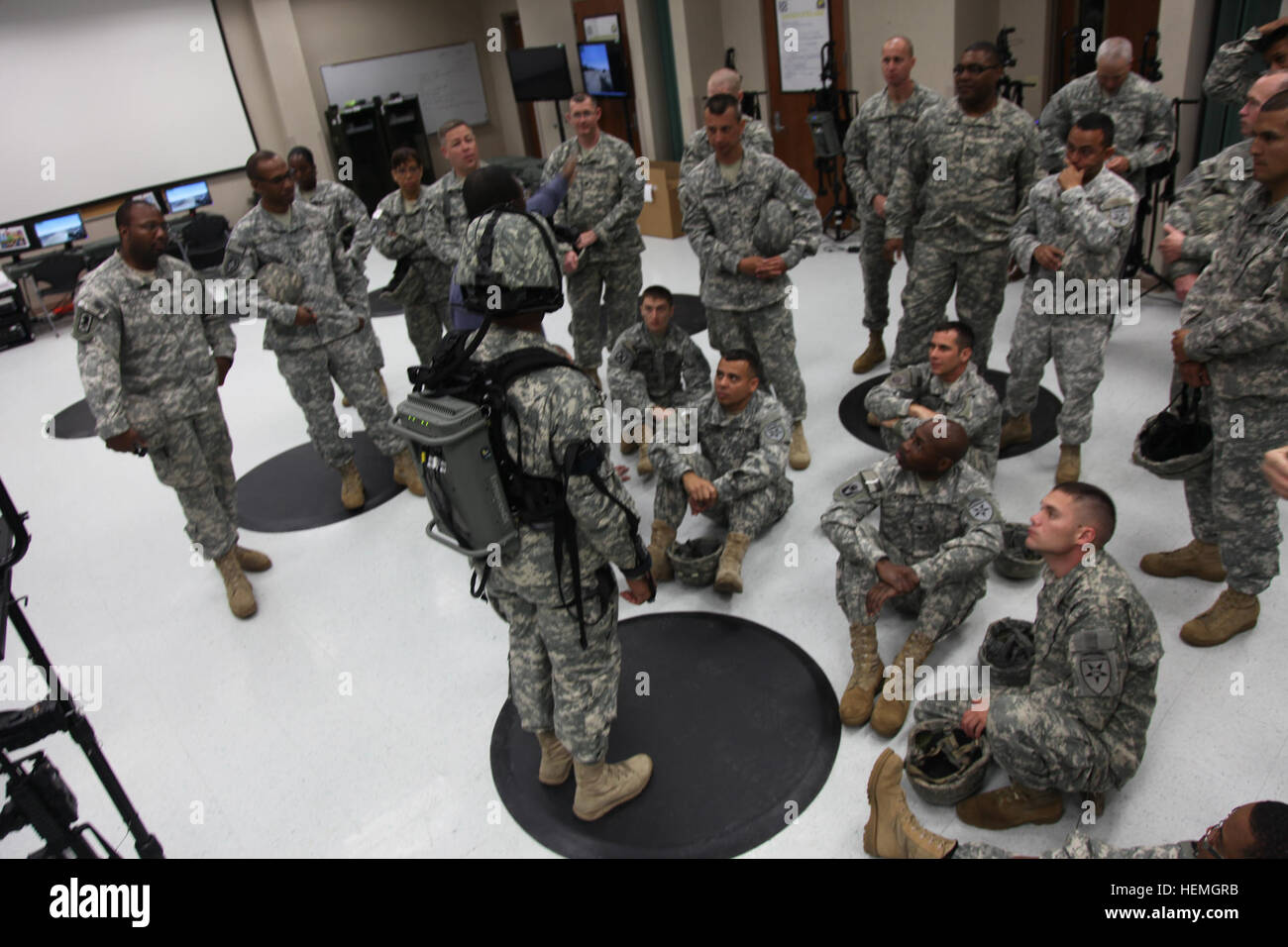 A group of U.S. Army Soldiers assigned to Mike, Lima, and Headquarters Troop, 4th Joint Communication Support Element (Airborne)/ 4 Joint Communication Support, are learning how to properly wear the Dismounted Soldier Training System equipment at Mission Command Training Branch Building, Fort Stewart, Ga., April 16, 2013. This training is helping Soldiers operate using a virtual environment as if they were on a real life mission on a foreign battlefield. (U.S. Army photo by Sgt. Austin Berner/Not Released) Virtual reality training 130416-A-BZ540-013 Stock Photo