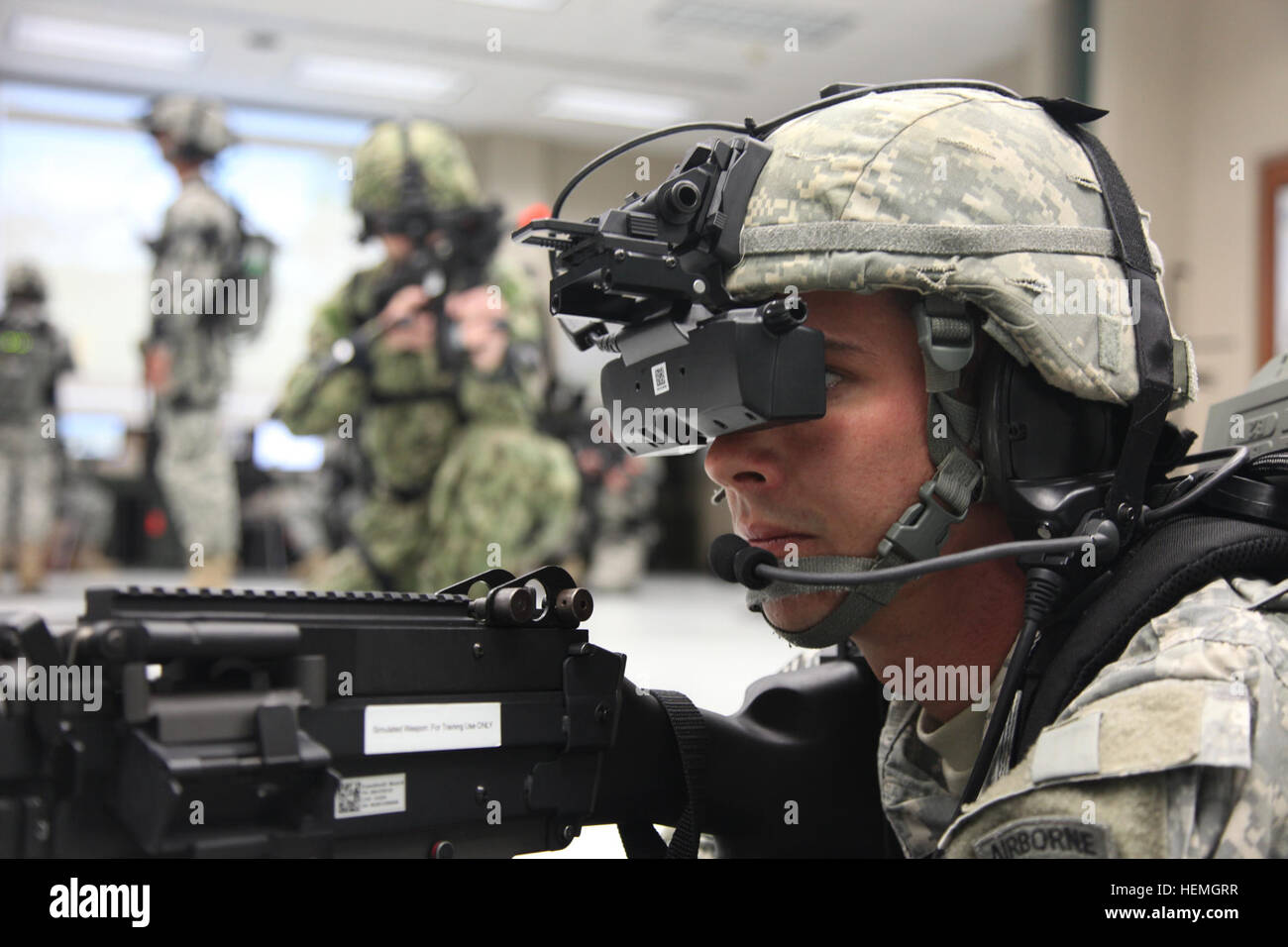 A group of U.S. Army Soldiers and Navy Sailors assigned to 4th Joint Communication Support Element (Airborne)/ 4 Joint Communication Support, are operating the Dismounted Soldier Training System in the prone position at Mission Command Training Branch Building, Fort Stewart, Ga., April 16, 2013. This training is helping Soldiers operate using a virtual environment as if they were on a real life mission on a foreign battlefield. (U.S. Army photo by Sgt. Austin Berner/Not Released) Virtual reality training 130416-A-BZ540-057 Stock Photo