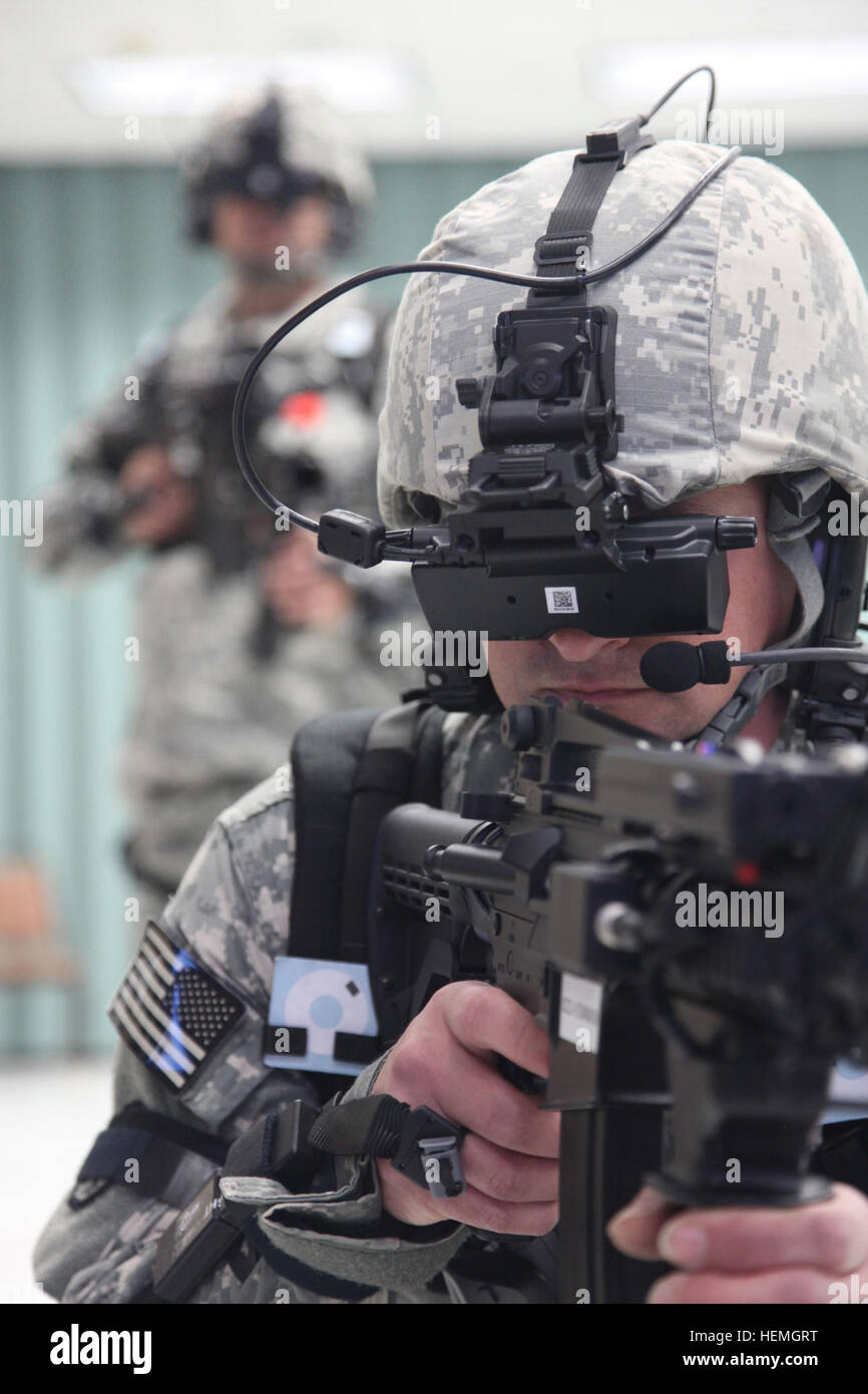 U.S. Army Sgt. Tony Golden and Spc. Daniel Henderson, assigned to Headquarters Troop, 4th Joint Communication Support Element (Airborne)/ 4 Joint Communication Support, are operating the Dismounted Soldier Training System at Mission Command Training Branch Building, Fort Stewart, Ga., April 16, 2013. This training is helping Sailors and Soldiers to operate using a virtual environment as if they were on a real life mission on a foreign battlefield. (U.S. Army photo by Sgt. Austin Berner/Not Released) Virtual reality training 130416-A-BZ540-052 Stock Photo