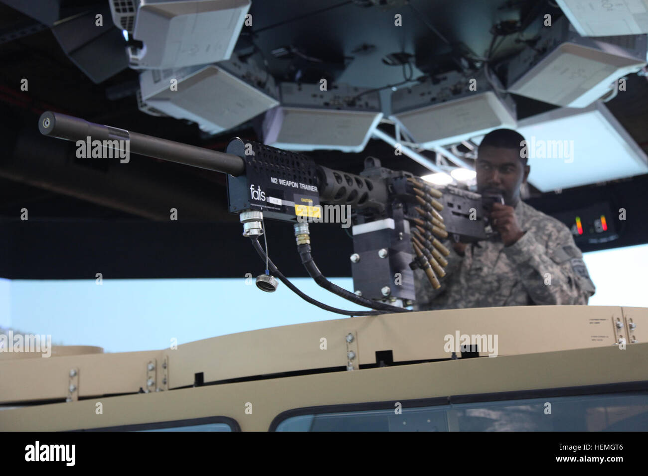 U.S. Army Staff Sgt. Darion Peek assigned to Lima Troop, 4th Joint Communication Support Element (Airborne)/ 4 Joint Communication Support, is manning a M2 .50 Caliber Machine Gun as the gunner of a convoy during a mounted virtual training exercise at Mission Command Training Branch Building, Fort Stewart, Ga., April 16, 2013. This training is helping Soldiers to operate using a virtual environment as if they were on a real life mission on a foreign battlefield. (U.S. Army photo by Sgt. Austin Berner/Not Released) Virtual reality training 130416-A-BZ540-078 Stock Photo