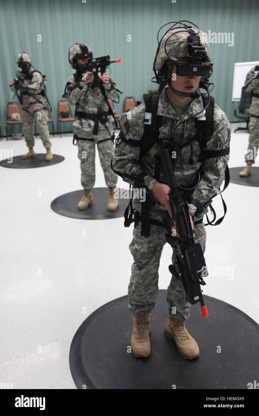 A group of U.S. Army Soldiers assigned to 4th Joint Communication Support Element (Airborne)/ 4 Joint Communication Support, are operating the Dismounted Soldier Training System in the standing position at Mission Command Training Branch Building, Fort Stewart, Ga., April 17, 2013. This training is helping Soldiers operate using a virtual environment as if they were on a real life mission on a foreign battlefield. (U.S. Army photo by Sgt. Austin Berner/Not Released) Virtual reality training 130417-A-BZ540-123 Stock Photo