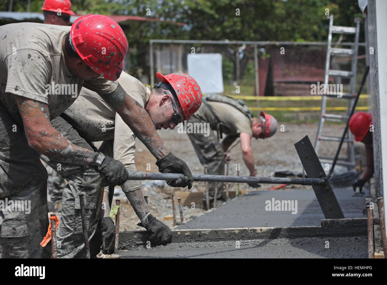 A group of Airmen assigned to the 200th Red Horse Squadron uses come-along to smooth out a new sidewalk in the town of Escobal, Colon, Panama, April 30, 2013. Beyond The Horizon 2013 – Panama is a U.S. Army South exercise providing engineering and medical support to rural communities in Panama. Conducted annually, these missions are part of U.S. Southern Command (SOUTHCOM) humanitarian and civic assistance program. (U.S. Army photo by Sgt. Austin Berner/ Released) Beyond the Horizon - Red Horse construction 030413-A-BZ540-124 Stock Photo