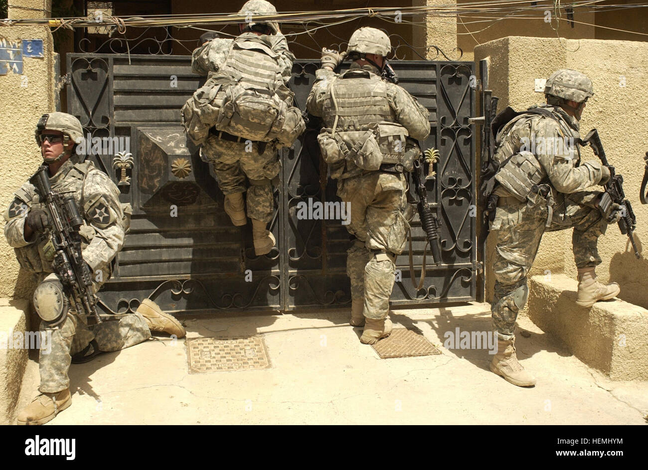 Soldiers from Company B, 1st Battalion, 23rd Infantry Regiment, 3rd Stryker Brigade Combat Team, 2nd Infantry Division attempt to breach a gate in order to enter and search a house during a combined cordon and search with the Iraqi National Police in the Rashid district of Baghdad on May 6. Operation Arrowhead Strike 10 44265 Stock Photo