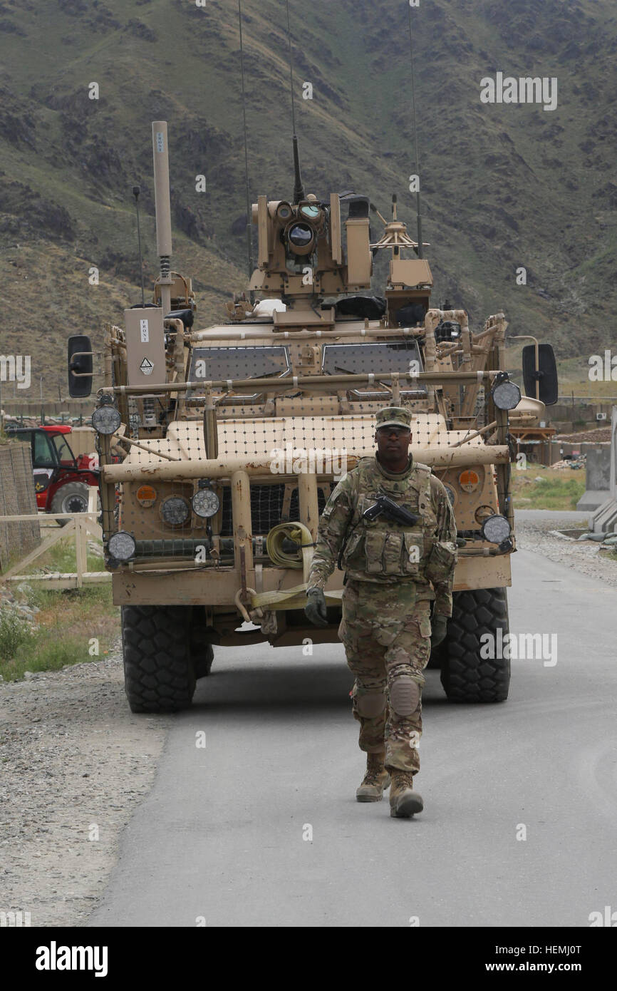 U.S. Army 1st Sgt. Michel Clayton assigned to Alpha Company, 426th Brigade Support Battalion, 1st Brigade Combat Team, 101st Airborne Division, ground guides a Mine-Resistant Ambush Protected All-Terrain Vehicle  during a retrograde operation at Forward Operation Base (FOB) Joyce, Kunar province, Afghanistan, 5 May, 2013. Soldiers from Alpha Company convoy to FOB Joyce to collect nonessential equipment and transport it back to Jalalabad Airfield. (U.S. Army photo by Spc. Vang Seng Thao/Released) Jersey Alexandria 130505-A-WI517-011 Stock Photo