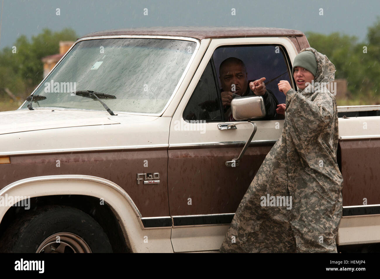 A U.S. Soldier with the Oklahoma Army National Guard directs a man ...