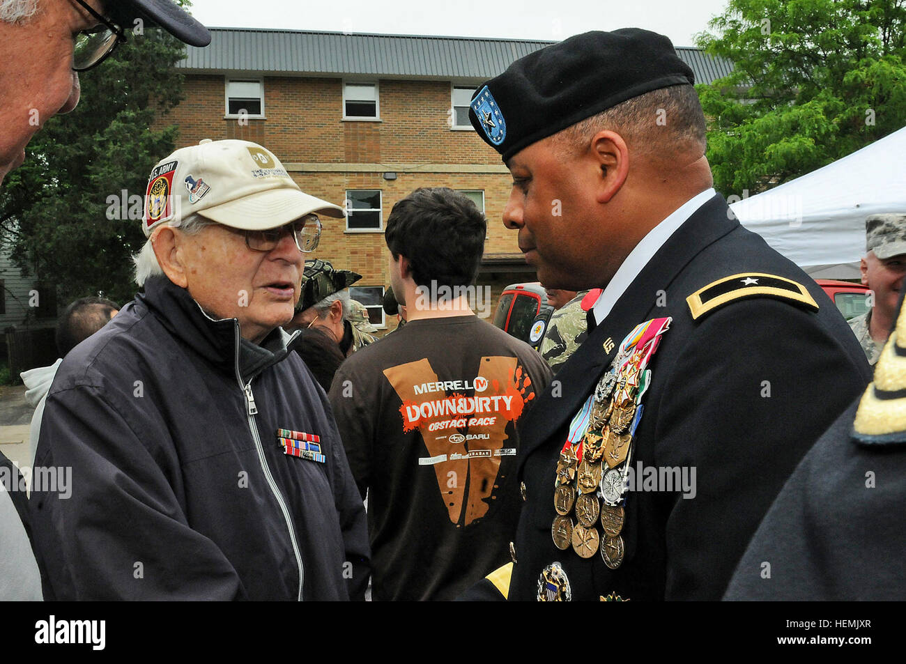 Paul Benson, World War II veteran who was part of the initial surge that stormed the beach of Normandy, meets Brig. Gen. Gracus K. Dunn, Commanding General, 85th Support Command, May 27, before the Memorial Day ceremony in Arlington Heights. Benson was awarded three Bronze Stars for his faithful service to our country during World War II and shares his story with whoever he meets at events such as the Arlington Heights Memorial Day parade and ceremony. Arlington Heights, Ill. hosts one of the largest Memorial Day parades in Illinois with close to 10, 000 spectators in attendance and 4,500 part Stock Photo
