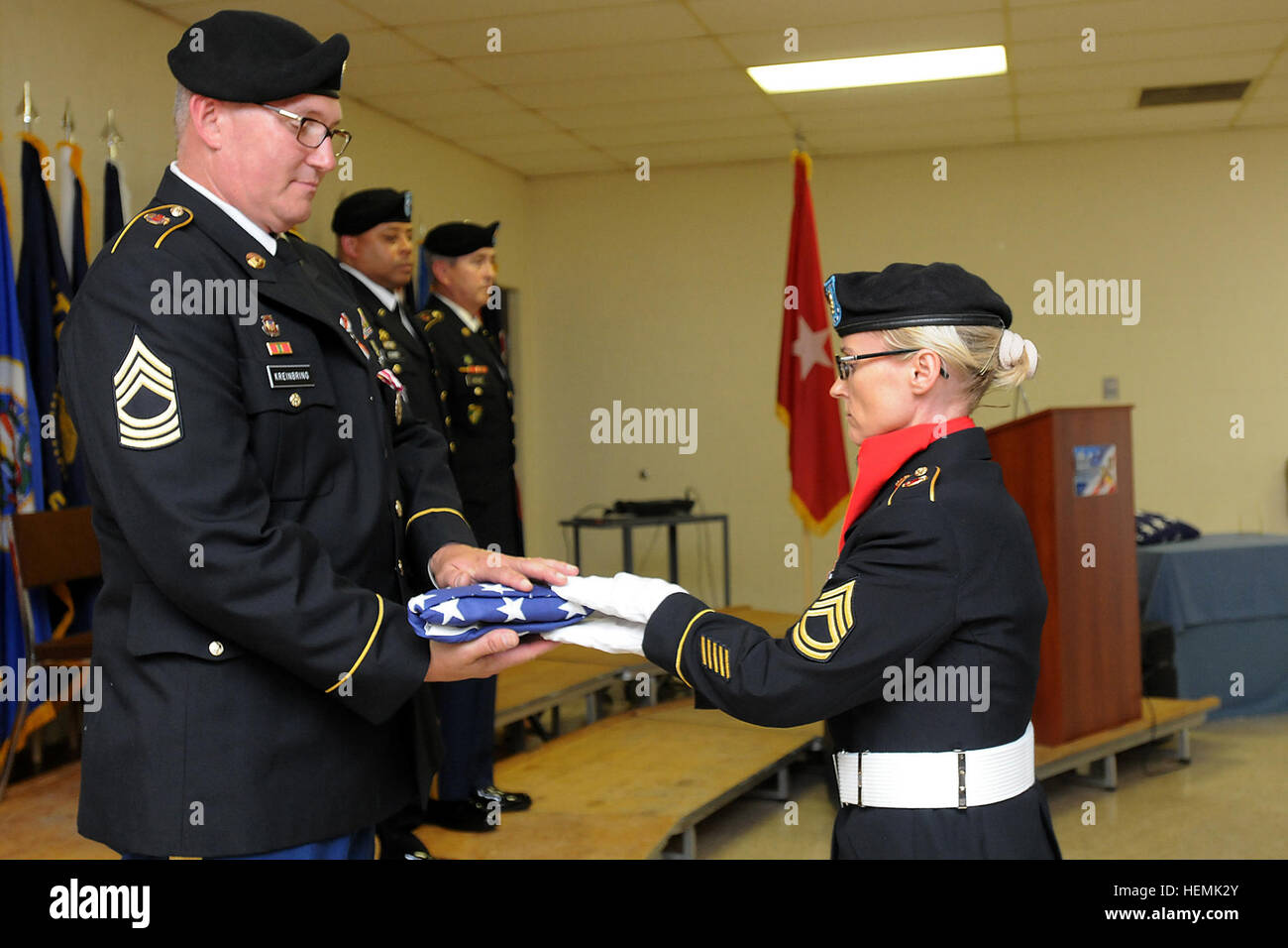 Sgt. 1st Class Maggie Cloud, 85th Support Command Color Guard, presented retired Master Sgt. Michael Kreinbring, former interim G-1 sergeant major, 85th SPT CMD, with the flag that was folded in his honor of service to the U.S. Army, Saturday, June 1, 2013.  Kreinbring entered the Army in July 1976 shortly after graduating high school, serving a total of 33 years between active duty, Army National Guard and the Army Reserve. During his retirement ceremony he was awarded the Meritorious Service Medal, the Retired Reserve lapel pin and a letter of appreciation for his service from President Bara Stock Photo