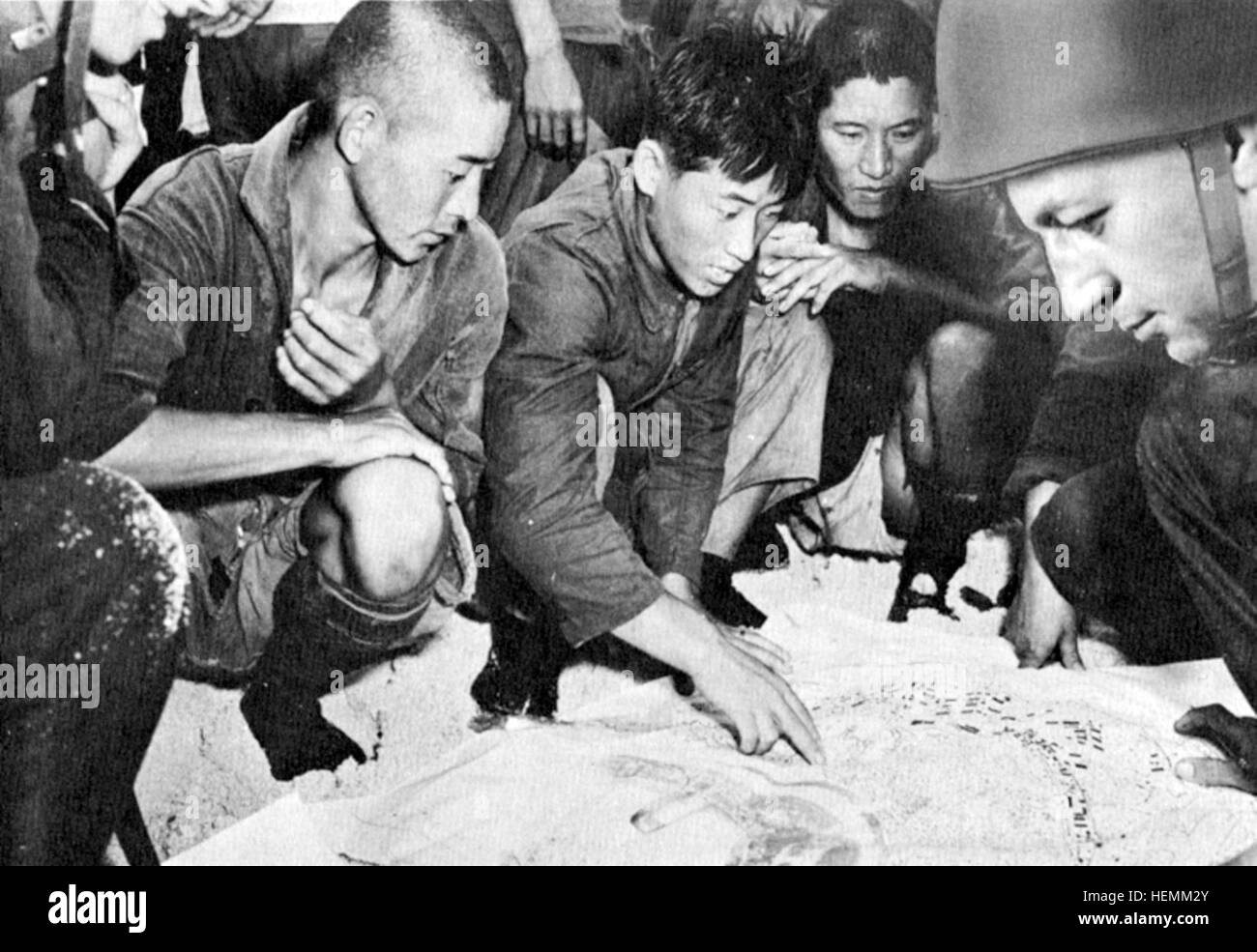 Korean laborers performing construction or maintenance work in a ...