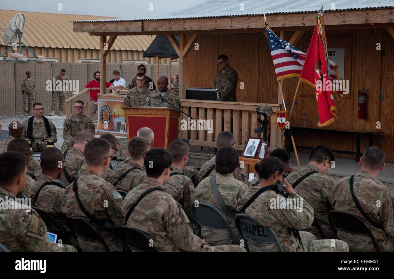 U.S. Army Staff Sgt. Darian George, the noncommissioned officer-in-charge for the 55th Signal Company (Combat Camera), 21st Signal Brigade, based in Fort Meade, Md., speaks about his Soldier, Spc. Hilda I. Clayton, during memorial ceremony at Forward Operating Base Gamberi in Laghman province, Afghanistan, July 8, 2013. Clayton died while photographing Afghan National Army soldiers conduct a live-fire training exercise when a mortar system failed and exploded, July 2.  (U.S. Army photo by Richard W. Jones, Jr./Released) Memorial ceremony held for fallen soldier at FOB Gamberi 130708-A-QU939-41 Stock Photo