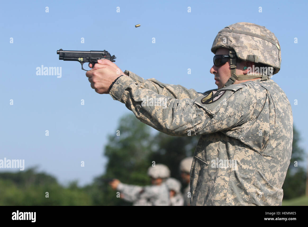 First Lt. Samuel Bader, executive officer of Headquarters and Headquarters Company, 303rd Maneuver Enhancement Brigade, 9th Mission Support Command fires the 9 mm pistol at the weapons qualification range July 18 at Fort McCoy, Wis. The 303rd MEB will be conducting a warrior exercise, Operation Compass Shield, there from July 23-30. (U.S. Army photo by Spc. David Harthcock) 1st Lt. Samuel Bader of the 303rd MEB fires the 9 mm pistol during 2013 WAREX 130718-A-VH612-241 Stock Photo