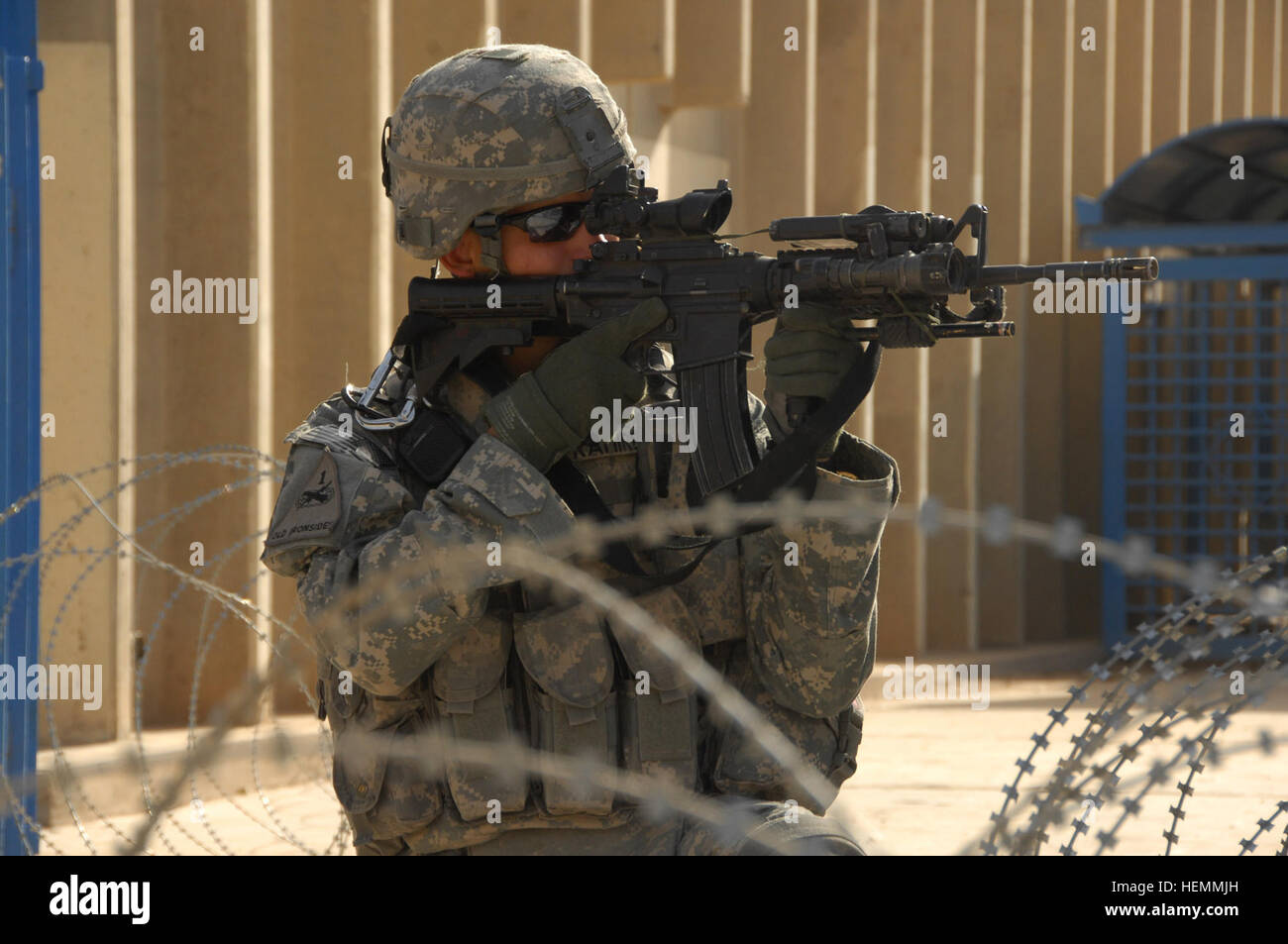 U.S. Army Sgt. Daniel Ramirez of Alpha Battery, 2nd Battalion, 32nd Field Artillery, 2nd Brigade Combat Team, 1st Cavalry Division, scans rooftops as he provides security at a business seminar in the Hateen neighborhood of Baghdad, Iraq, on Sept. 12. 1st Cav. Soldiers Provide Security for Business Seminar 57473 Stock Photo