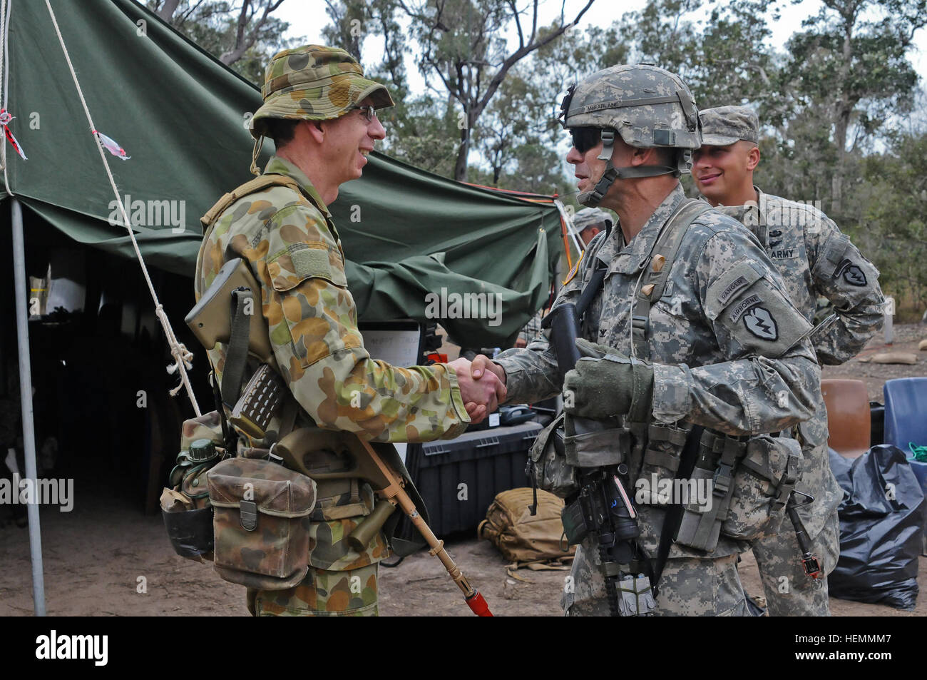 Battlefield commanders Col. Edward Smeaton, with the Force Support Group, 17th Combat Service Support Brigade, Australian Army (left), and Col. Matthew McFarlane, with the 4th Infantry Brigade Combat Team (Airborne), 25th Infantry Division, U.S. Army, meet to review sector defenses and boundaries, and to further strengthen relations between the two allies during Talisman Saber 2013 at the 4-25's Assault Command Post located at the Shoalwater Bay Training Area in Queensland, Australia July 23. The 4-25 executed a forced entry airborne assault, seizing a lodgment, with a force size of 400 paratr Stock Photo