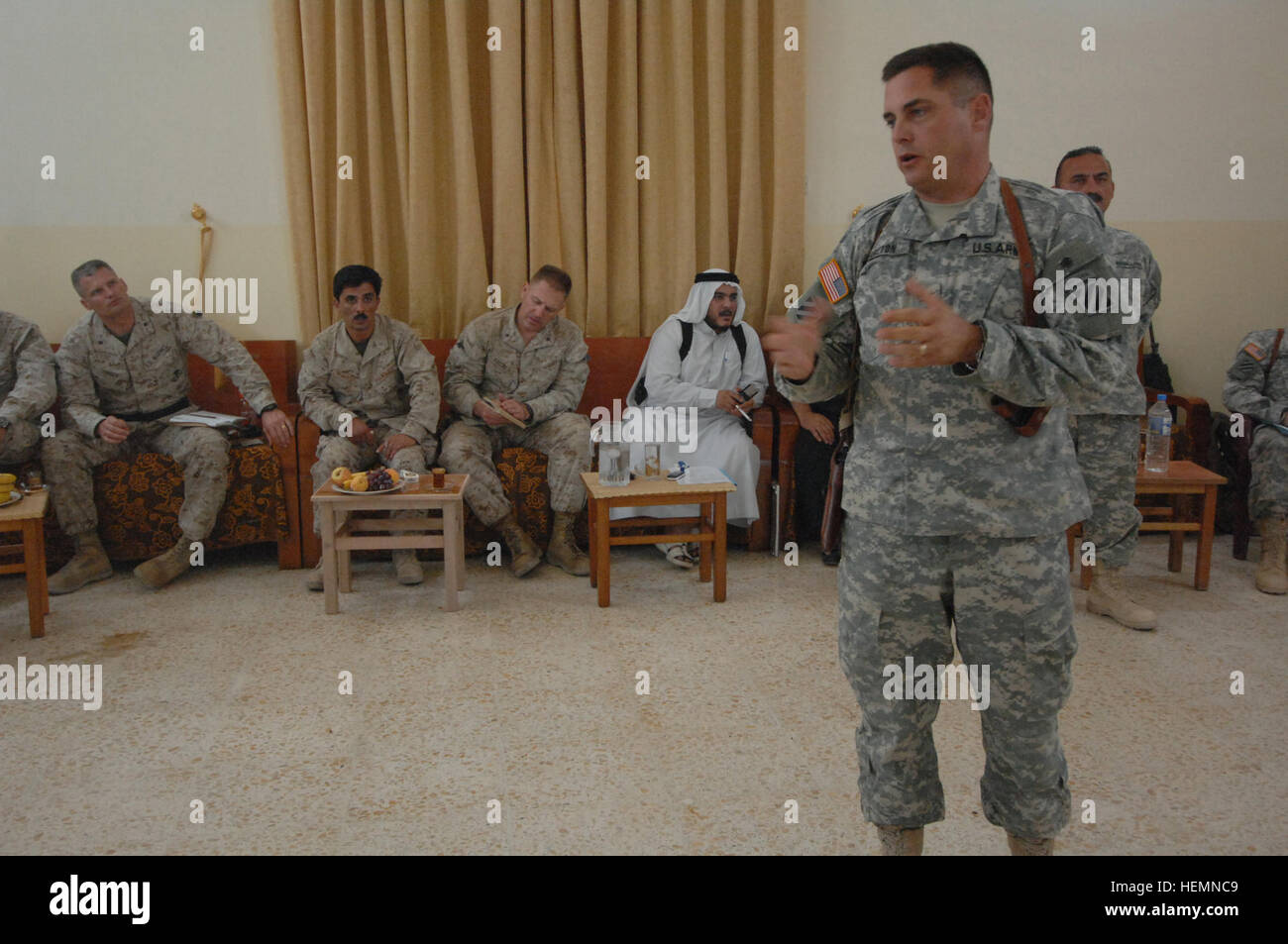 U.S. Army Col. John Charlton attached to 1st Brigade, 3rd Infantry Division, II Marine Expeditionary Force, speaks at a local council meeting attended by local government officials, Iraqi army, and Iraqi police in the city of Ar Ramadi, Iraq, on  Sept. 17. The meeting, held at Sheik Amir Ali Khataub's house, covers issues of city redevelopment as well as current issues on the fight against terrorism. Ar Ramadi meeting 60287 Stock Photo