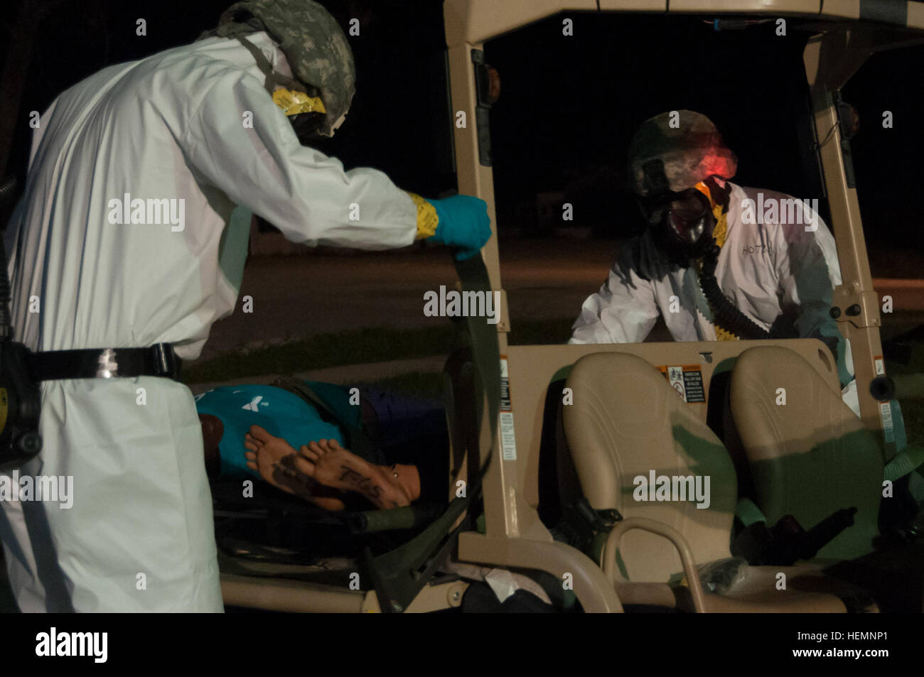 Soldiers from the 44th Chemical Company from Fort Hood, Texas, load simulated casualties on the back of a utility vehicle here as part of Vibrant Response 13-2 Aug 13. After the casualties were decontaminated, the 546th Medial Company (Area Support), also from Killeen, Texas, treated their injuries. Approximately 5,700 service members and civilians from the military and other local, state and federal agencies are training to respond to a catastrophic domestic incident. (U.S. Army photo by Spc. Bradley J. Wancour, 13th Public Affairs Detachment) Fort Hood, Fort Benning units perform decontamina Stock Photo