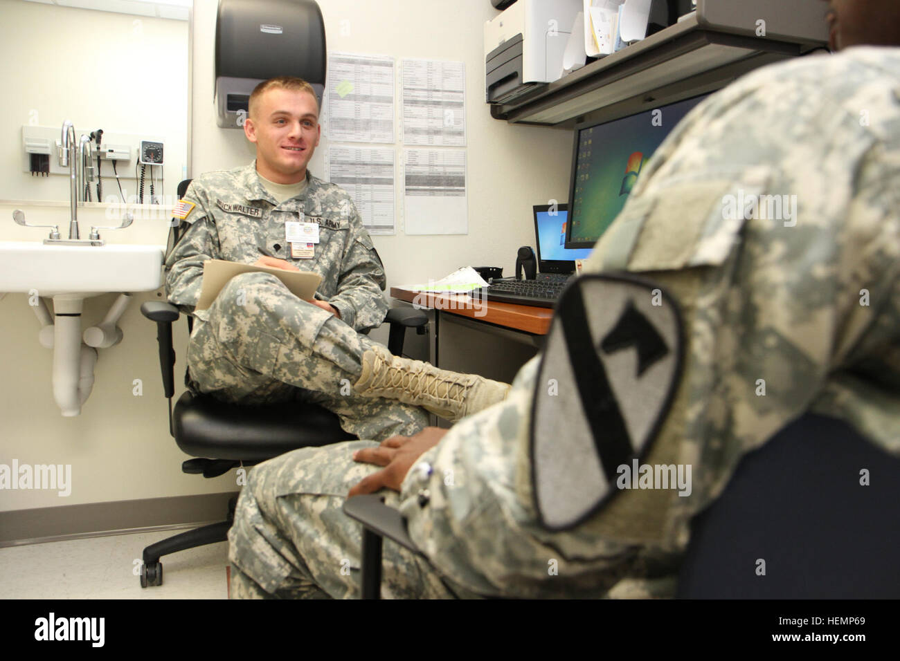 Spc. Jack Buckwalter, a Stewartsville, N.J. native and mental health  specialist with Headquarters and Headquarters Company, 1st Air Cavalry  Brigade, 1st Cavalry Division, provides triage to a soldier during a  behavioral health