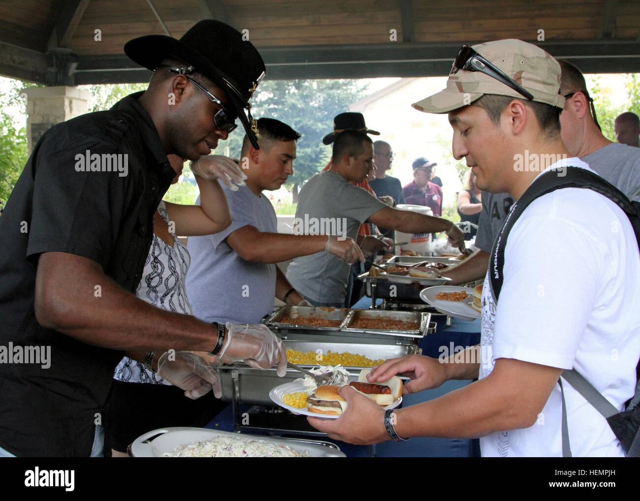Manning, S.C., native, Capt. Matthew Canty (left), the human resources officer for the 2nd 'Stallion' Battalion, 8th Cavalry Regiment, 1st 'Ironhorse' Brigade Combat Team, 1st Cavalry Division, serves Lawrence, Mass., native, Sgt. Ricardo Perez (right)  pasta salad during a barbecue for Wounded Warriors and their families at BAMC, Sept. 6. 'It feels great to know someone cares about us,' said Perez, who is a soldier currently assigned to the Warrior Transition Unit at the Brooke Army Medical Center in San Antonio. (U.S. Army photo by Sgt. Bailey Kramer, 1st BCT PAO, 1st Cav. Div.) Stallions, S Stock Photo
