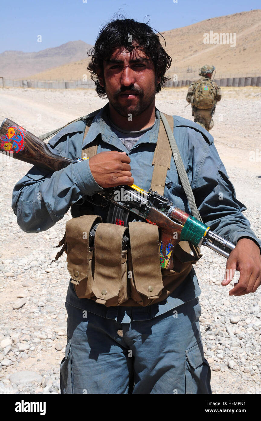 An Afghan National Policeman from Char Chineh district, Uruzgan province, provides security to a shura at the district governor's compound in Shahid-e Hassas. Uruzgan security forces repel attacks 130909-A-CM658-648 Stock Photo