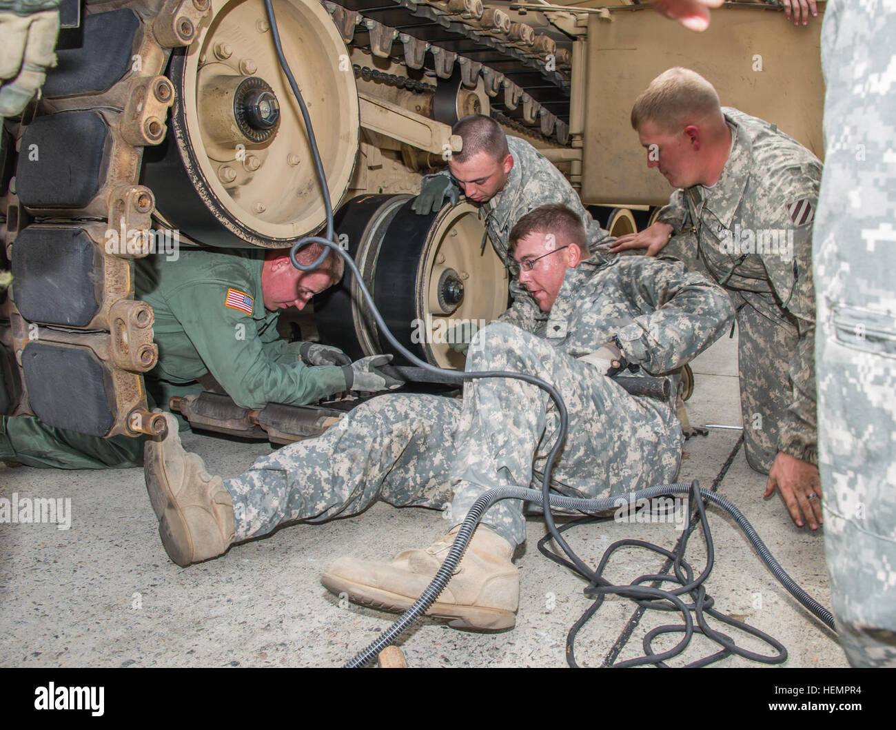 Soldiers from Company C 'Cyclones', 1st Battalion, 64th Armor Regiment, 2nd Armored Brigade Combat Team, 3rd Infantry Division, try to get the quickest time completing a track removal and reinstallation on a M1A2 SEPV2 Abrams tank at their battalion's motorpool here, Sept. 10. This timed event was designed to simulate the actions a crew may have to take if the tank was to break track in a real time situation, and was just one part of a 13-event, three-day competition, designed to bolster Esprit de Corps, as well as help the Cyclones prepare for the gunnery they have coming up in the fall. (U.S Stock Photo