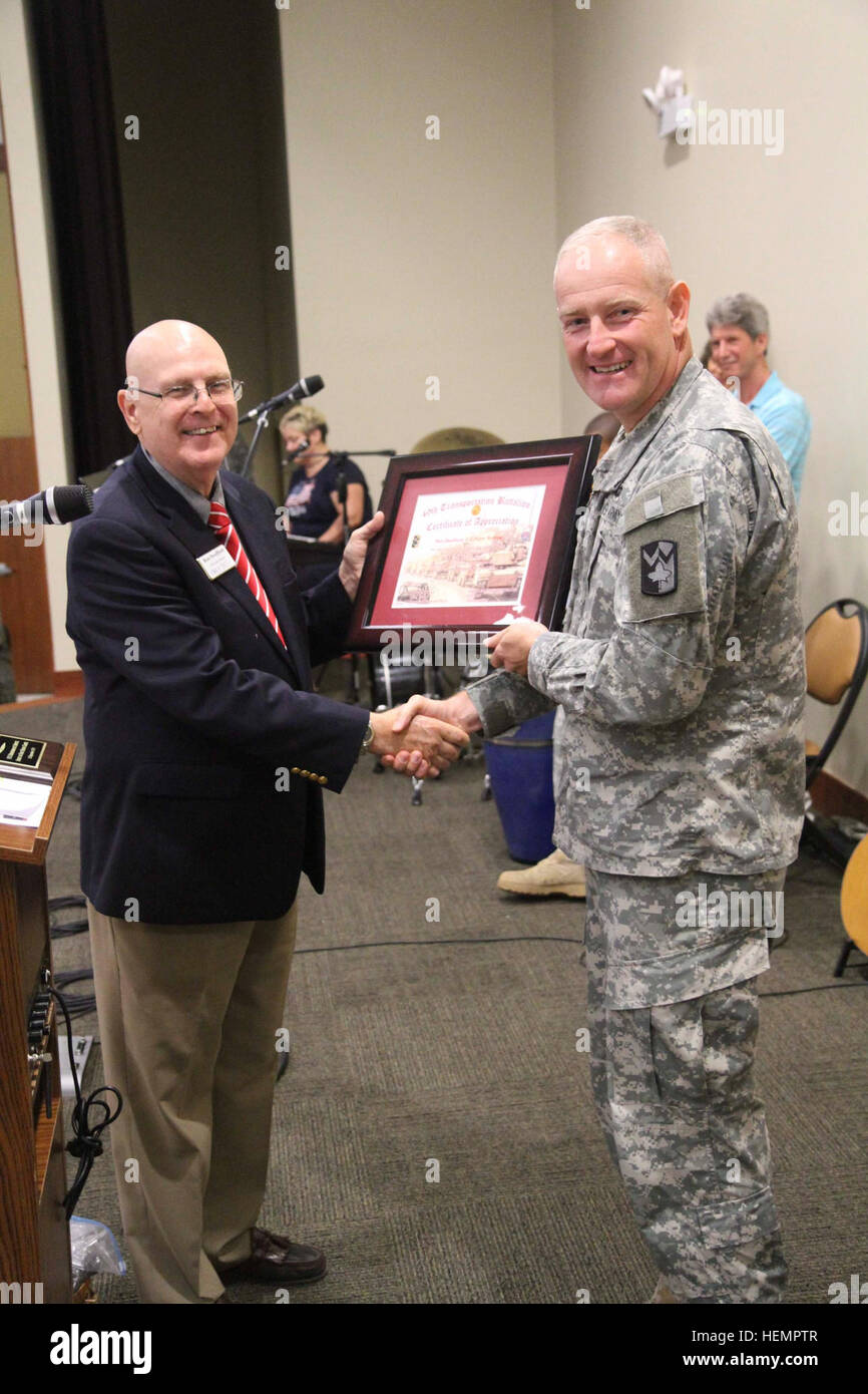 Lt. Col. Charles Blumenfeld, commander of the 49th Transportation Battalion, 4th Sustainment Brigade, 13th Sustainment Command (Expeditionary), presents a Certificate of Appreciation to guest speaker, retired U.S. Navy Chaplain Ron Swafford. Swafford was presented with the certificate and other tokens of appreciation for coming to talk to the Wrangler soldiers, in particular the younger soldiers, about the events of 9/11 during a Memorial Prayer Breakfast at the Spirit of Fort Hood Chapel, Sept. 11, 2013. (Photo by Sgt. 1st Class Chris Bridson, 4th Sust. Bde. PAO, 13th ESC.) Wranglers remember Stock Photo