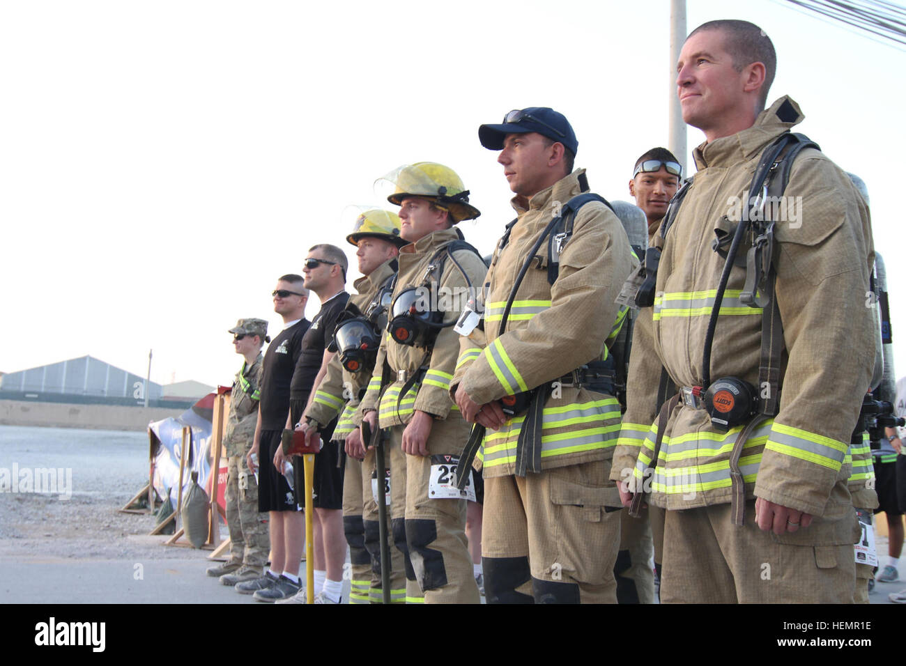 One of the firefighter teams gets ready to start the 'Tunnel to Towers' five kilometer run/walk at Kandahar Airfield, Kandahar province, Afghanistan, Sept. 14, 2013. The event benefited the Tunnel to Towers foundation, which raises money to build homes for disabled firefighters and members of the armed forces around the U.S. (U.S. Army Photo by Cpl. Clay Beyersdorfer/Released) Tunnel to Towers comes to Afghanistan 130914-A-HP669-573 Stock Photo