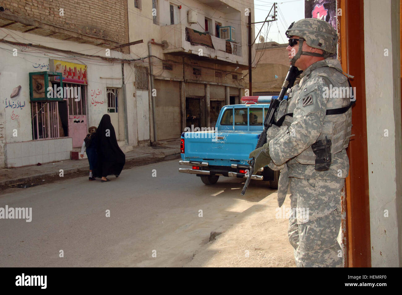 U.S. Army Sgt. 1st Class Donald Bryan, of 1st Armored Division 2nd Stryker Cavalry Regiment 4th Squadron Quick strike Troop, pulls security outside during a meeting at a police station in the Muhaila neighborhood of Baghdad, Iraq, on Oct. 1. The visit was part of an ongoing validation of Iraqi police in the neighborhood. Validation of Iraqi police 62328 Stock Photo