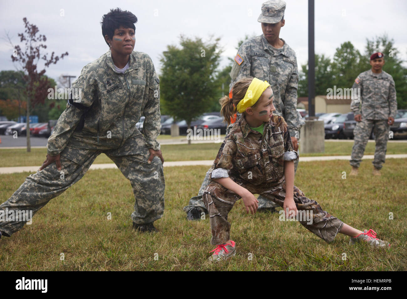 Spouses and children of Soldiers assigned to the 55th Signal Company (Combat Camera) stretch during the company's 'Day In Their Boots' event at Fort George G. Meade, Md., Sept. 27, 2013. Families and spouses participated in multiple events including an obstacle course, simulated rifle range, and land navigation to experience the daily life of being a Soldier.  (U.S. Army photo by Spc. Philip Diab/Released) A Day in Their Boots 131127-A-GQ805-004 Stock Photo