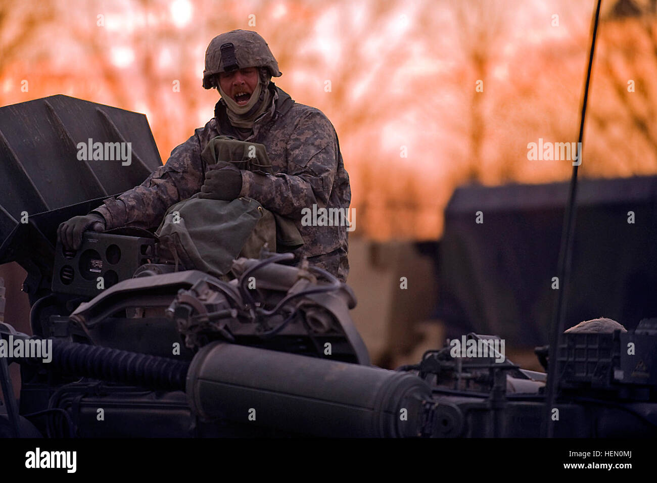 Indiana National Guard Sgt. Steven Cohee, artilleryman from Brazil, Ind., with Battery B, 2nd Battalion, 150th Field Artillery Regiment headquartered in Rockville, Ind., sits on top of his team's M777 Howitzer directing his soldiers to move the gun in position to fire on a Camp Atterbury Joint Maneuver Training Center range, Nov. 4. The Indiana National Guard fired the weapon system for the first time at Camp Atterbury after a 10-day familiarization course with its new cannons. Indiana Guard Fires Historic Artillery Mission 338696 Stock Photo