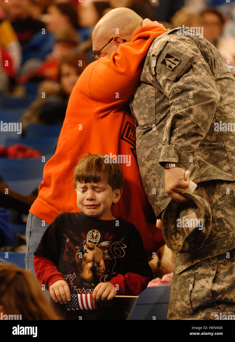 Sgt. Shane Pudgett hugs his wife goodbye as his son, Bryce, age 5, sheds a tear on Jan. 2 at the RCA Dome in Indianapolis. This will be the largest Indiana National Guard deployment since World War II, with more than 3,400 Soldiers from about 30 Indiana communities are scheduled to deploy to Iraq for 12-months. The brigade, headquartered in Indianapolis, is commanded by Col. Courtney Carr and Command Sgt. Maj. Gregory Rhoades. 76th Bde Departure Ceremony 71172 Stock Photo