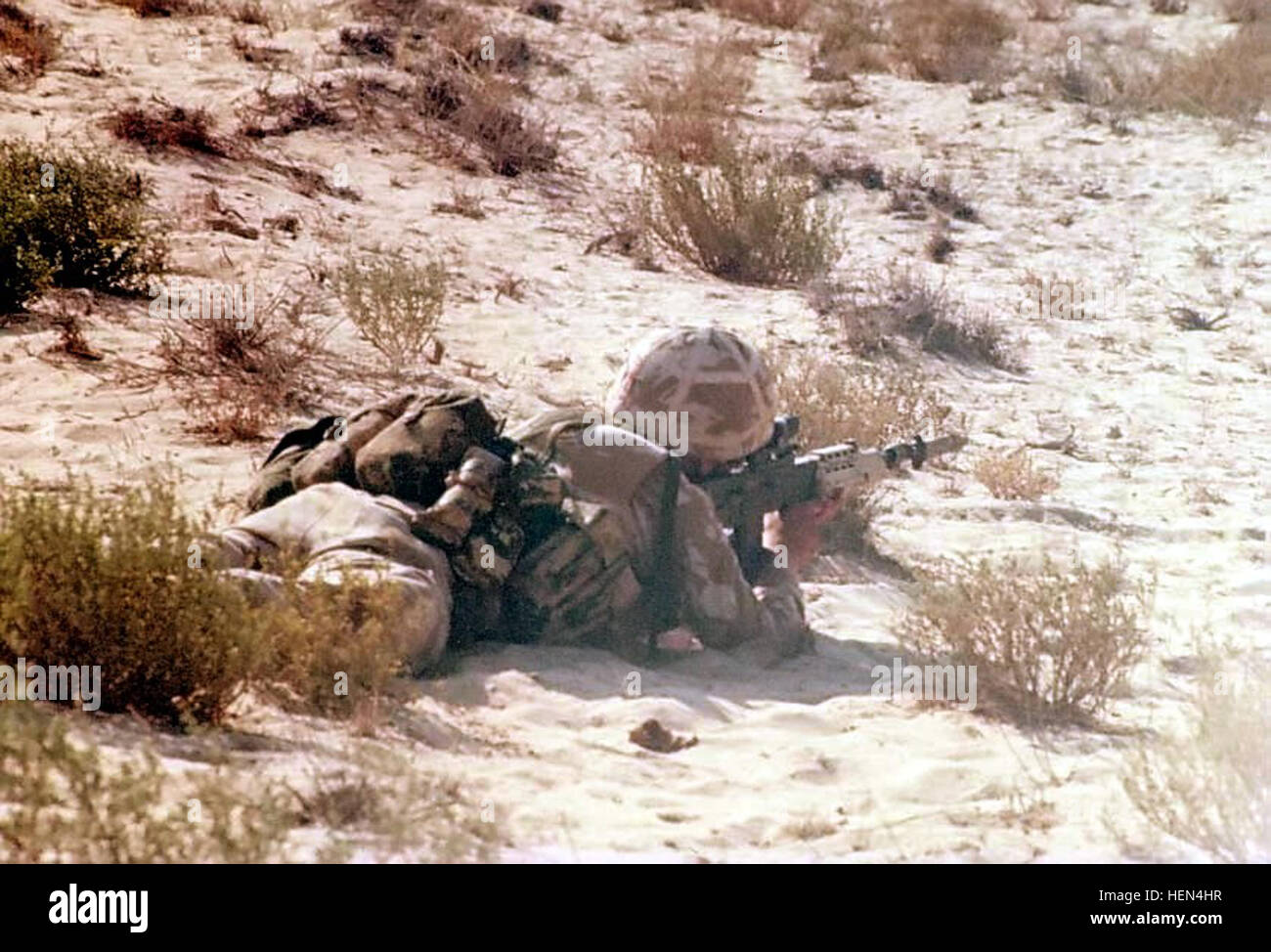A British soldier is equipped with an L85 assault rifle, conducting ...