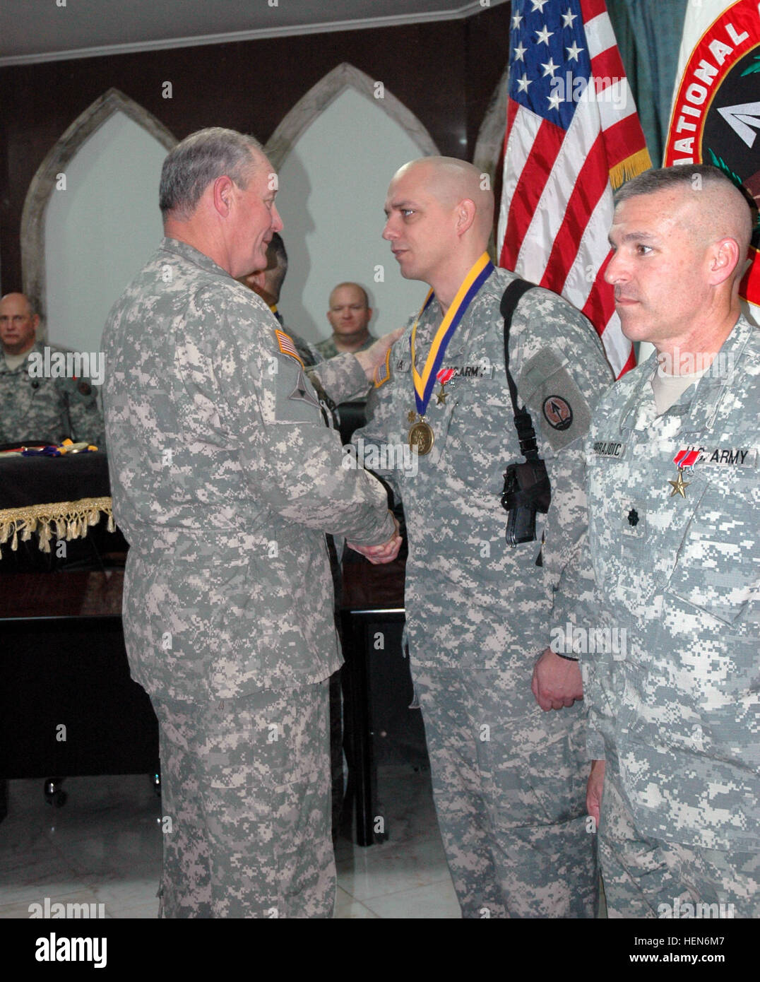 In a ceremony held in the Al Faw Palace, Camp Victory, Iraq, on Jan. 14, Maj. Gen. James E. Simmons, Multi-National Corps-Iraq, deputy commanding general for support presented Maj. Allen G. Hahn, Multi-National Corps-Iraq, C3 Aviation Operations Officer, with the Order of St. Michael Medallion (bronze). The award history states that St. Michael is referred to in Biblical writings as an archangel who wages war against evil. He is known as the heavenly prince or champion, charged specifically to guard and defend others. The legendary image of St. Michael defeating the dragon exemplifies the brav Stock Photo
