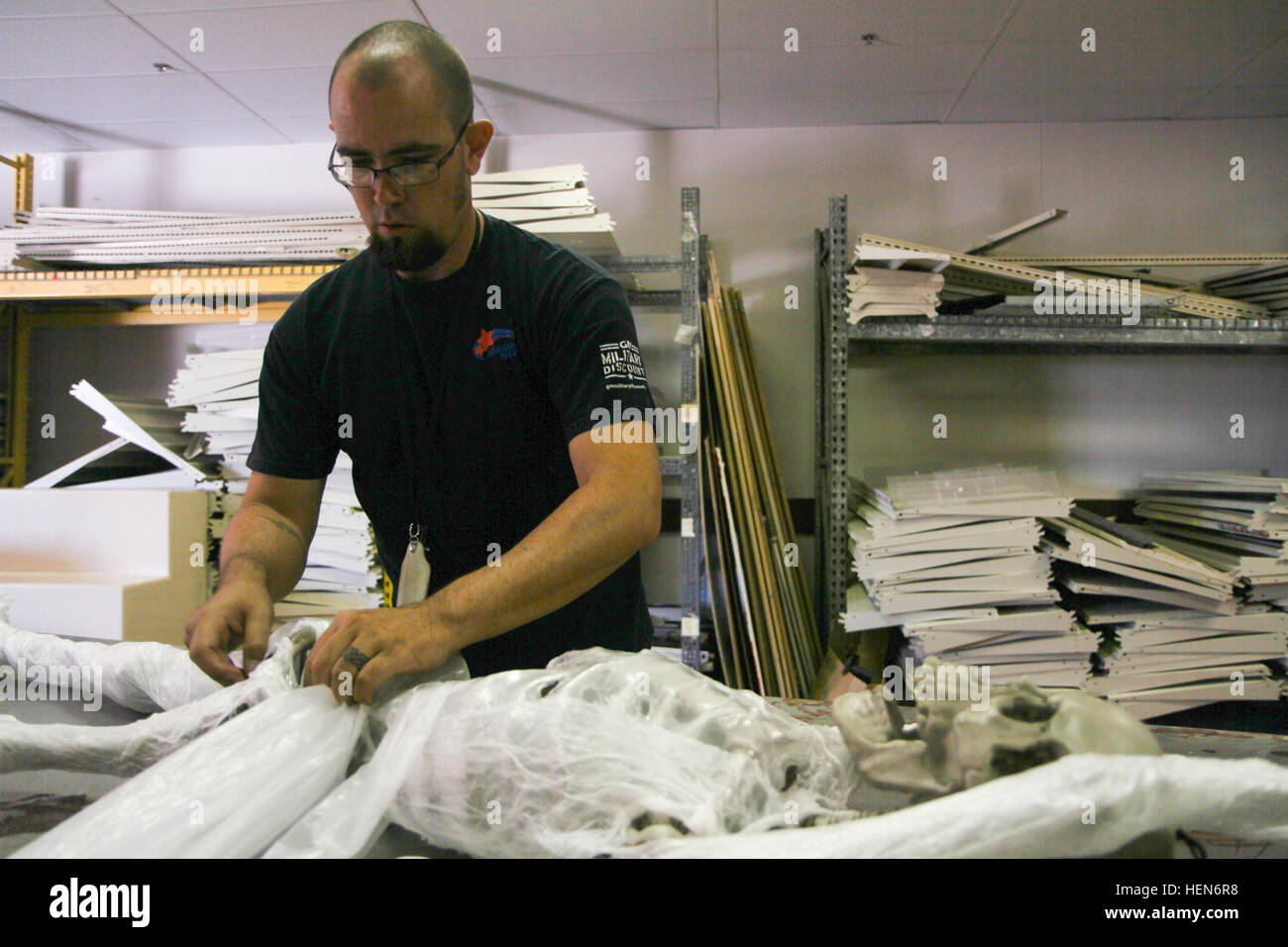 Chris Bohn, a Family and Morale, Welfare and Recreation special event coordinator at Fort Bliss, Texas, prepares a fake skeleton, Oct. 9, 2013, to be shrink-wrapped in plastic as part of creating a mummy for the “Massacre on Marshall Road” haunted house at the Trading Post at Fort Bliss. (U.S. Army photo by Sgt. Robert Golden, 16th Mobile Public Affairs Detachment) Massacre on Marshall Road 131009-A-LH369-004 Stock Photo