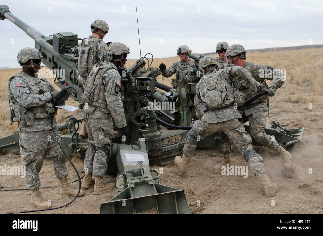 Pvt. Michael Cuff (loading-left), of Klamath Falls, Ore., and Pfc. Bryan Kicklighter (loading-right), of Manassas, Va., Battery C, 1st Battalion, 37th Infantry Regiment, 3-2 Stryker Brigade Combat Team, 7th Infantry Division, Joint Base Lewis-McChord, load a round into M777A2 howitzer cannon at Yakima Training Center, Wash., Oct. 9. The 'Red Lions' are conducting live-fire exercises in support of infantry operations being conducted elsewhere on YTC. (U.S. Army photo by Staff Sgt. Chris McCullough) 1-37 FA rains down steel on Yakima Training Center 131009-A-ET795-202 Stock Photo