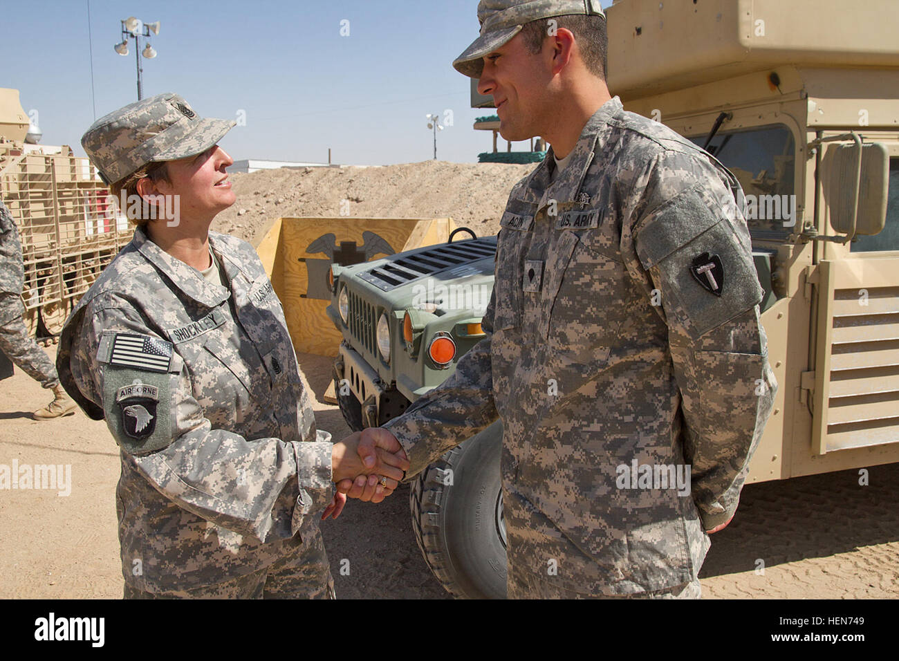 Spc. Wesley Acuna is congratulated by 36th Combat Aviation Brigade Command Sgt. Maj. Elizabeth Shockley after he received the Expert Field Medical Badge during a ceremony at Camp Buehring in Kuwait.  Spec. Acuna is deployed to the Middle East in support of Operation Enduring Freedom. (U.S. Army photo by Sgt. Mark Scovell/Released) Texas soldier earns Expert Field Medical Badge 101613-A-AY590-031 Stock Photo