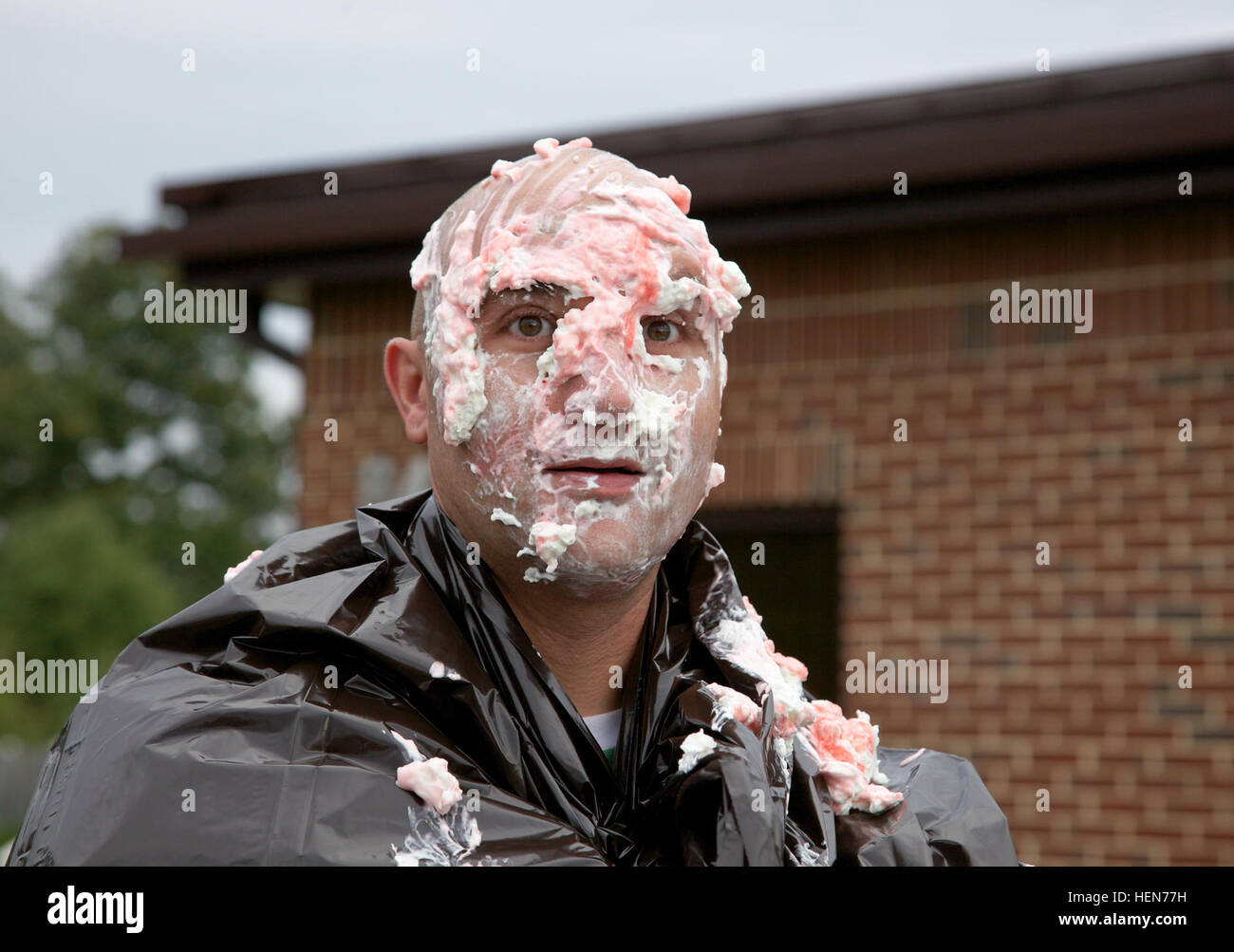 U.S. Army Sgt. Richard Jones poses with pie on his face during a Family Readiness Group event at the 55th Signal Company, Fort George G. Meade, Md., Oct. 17, 2013. The FRG event was conducted to raise money, while giving soldiers the opportunity to bid on a pie to hit a senior leader with. (U.S. Army photo by Sgt. Evangelia Grigiss/Released) FRG Pie in the Face Fundraiser 131017-A-LQ527-565 Stock Photo