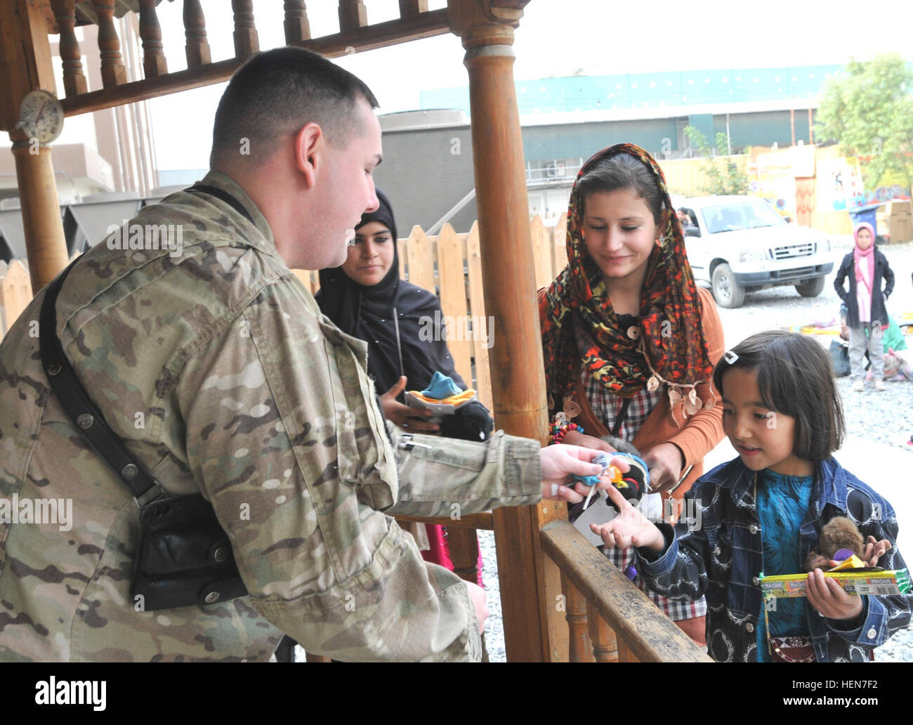 At the New Kabul Compound in Afghanistan, U.S. Army personnel interact with  Afghan children during the Afghan Women's Bazaar, where local women and  children sell crafts and souvenirs to support their families.