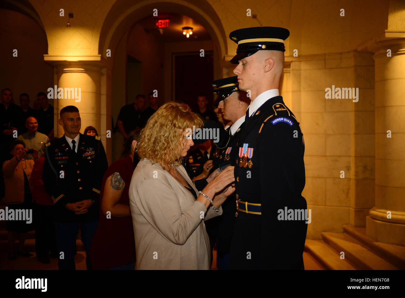 Staff Sgt. Robbie Petry, Spc. John Arriaga and Spc. Samuel Barnett, of the 3d U.S. Infantry Regiment (The Old Guard), receive the Tomb of the Unknown Soldier Identification Badge during a badge ceremony inside the Memorial Amphitheater Chapel in Arlington National Cemetery, Va., Oct. 24, 2013. Petry received badge #618, Arriaga badge #619 and Barnett badge #620. It is the second-least awarded badge in the U.S. Army, after the Astronaut Badge. Sentinels guard the Tomb of the Unknown Soldier 24 hours a day, 365 days a year despite any weather condition. (U.S. Army photo by Sgt. Jose A. Torres Jr Stock Photo