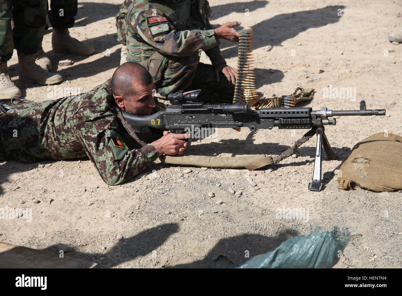 The Afghan National Army Sergeant Major of the Army Roshan Safi test fires a M240B machine gun during a VIP visit to the Commando School of Excellence, Kabul province, Afghanistan, Oct. 29, 2011. The Afghan SMA was visiting the school to tour the facilities and observe class demonstrations. (U.S. Army photo by Spc. Matthew Minkema)(Released) VIP visit 481555 Stock Photo