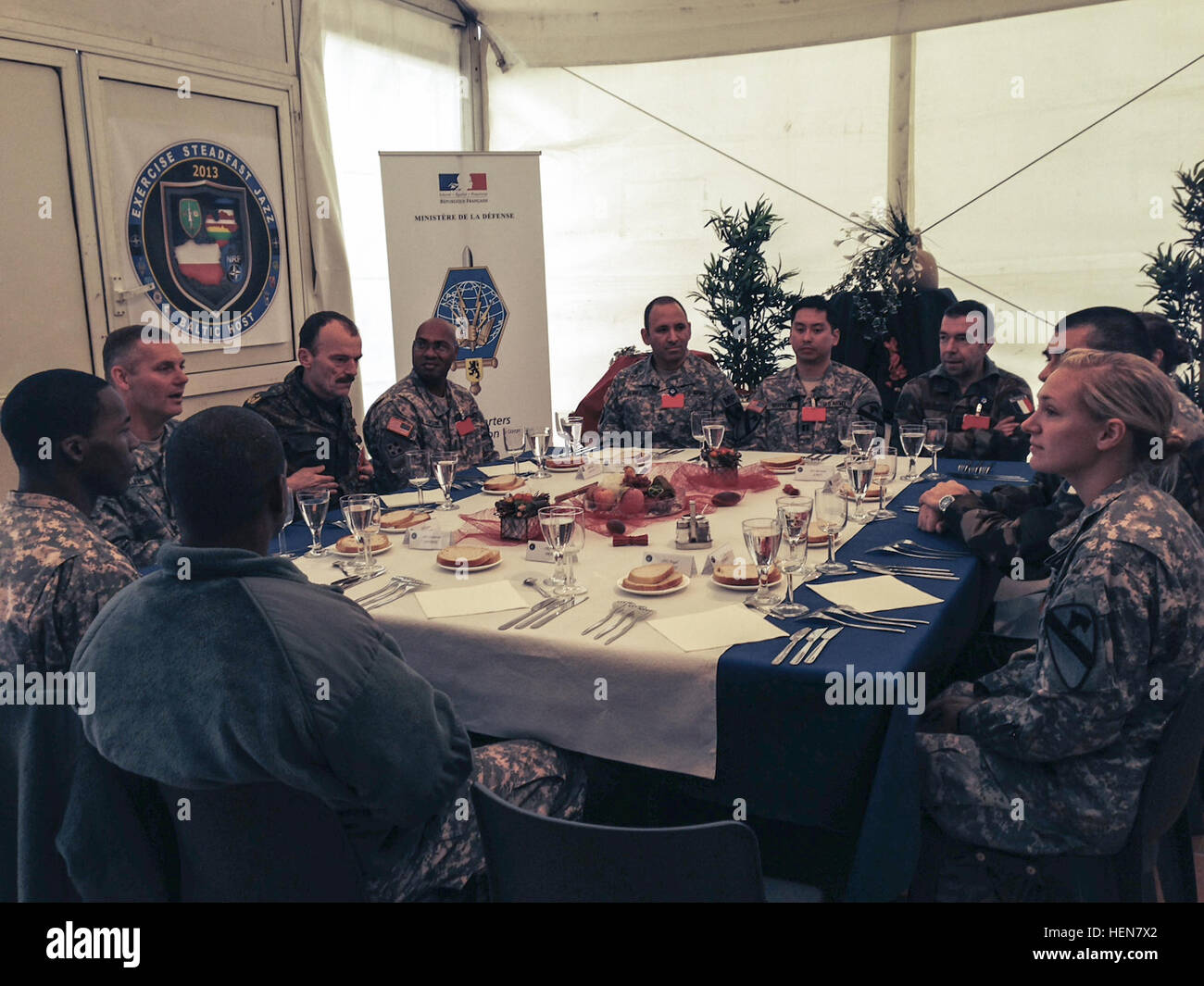 Soldiers of the 1st Brigade Combat Team, 1st Cavalry Division have lunch with the commander of Headquarters Rapid Reaction Corps - France, Lt. Gen. Eric Margail during Steadfast Jazz 2013 in Drawsko, Poland. SFJZ 13 is a NATO sponsored exercise to train, valuate and certify the NATO Response Force. (The badges in this image have been altered for security purposes). Ironhorse Brigade participates in Steadfast Jazz 2013 131101-A-ZZ247-056 Stock Photo