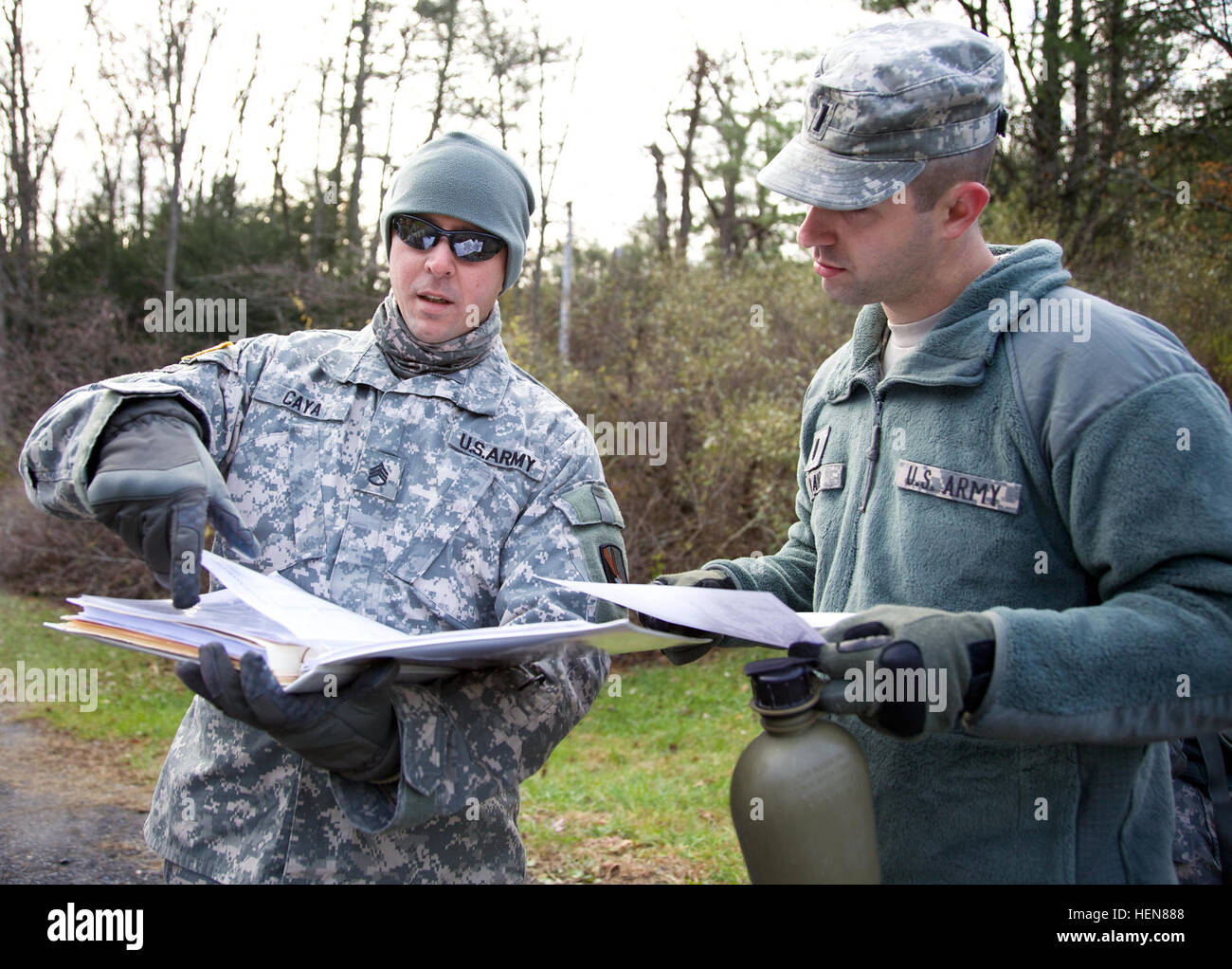 U.S. Army Staff Sgt. Michael Caya and 1st Lt. Jared Blair, attached to 55th Signal Company (Combat Camera), review paperwork during a tactical field training exercise (FTX) at the Ft. Indiantown Gap National Guard Training Center, Annville, Pa., Nov. 5, 2013. The FTX is conducted quarterly to bring soldiers together and practice tactical training from the Army Mission Essential Task List as a battalion. (U.S. Army photo by Sgt. Evangelia Grigiss/Released) 114th Signal Battalion field training exercise 131105-A-LQ527-014 Stock Photo