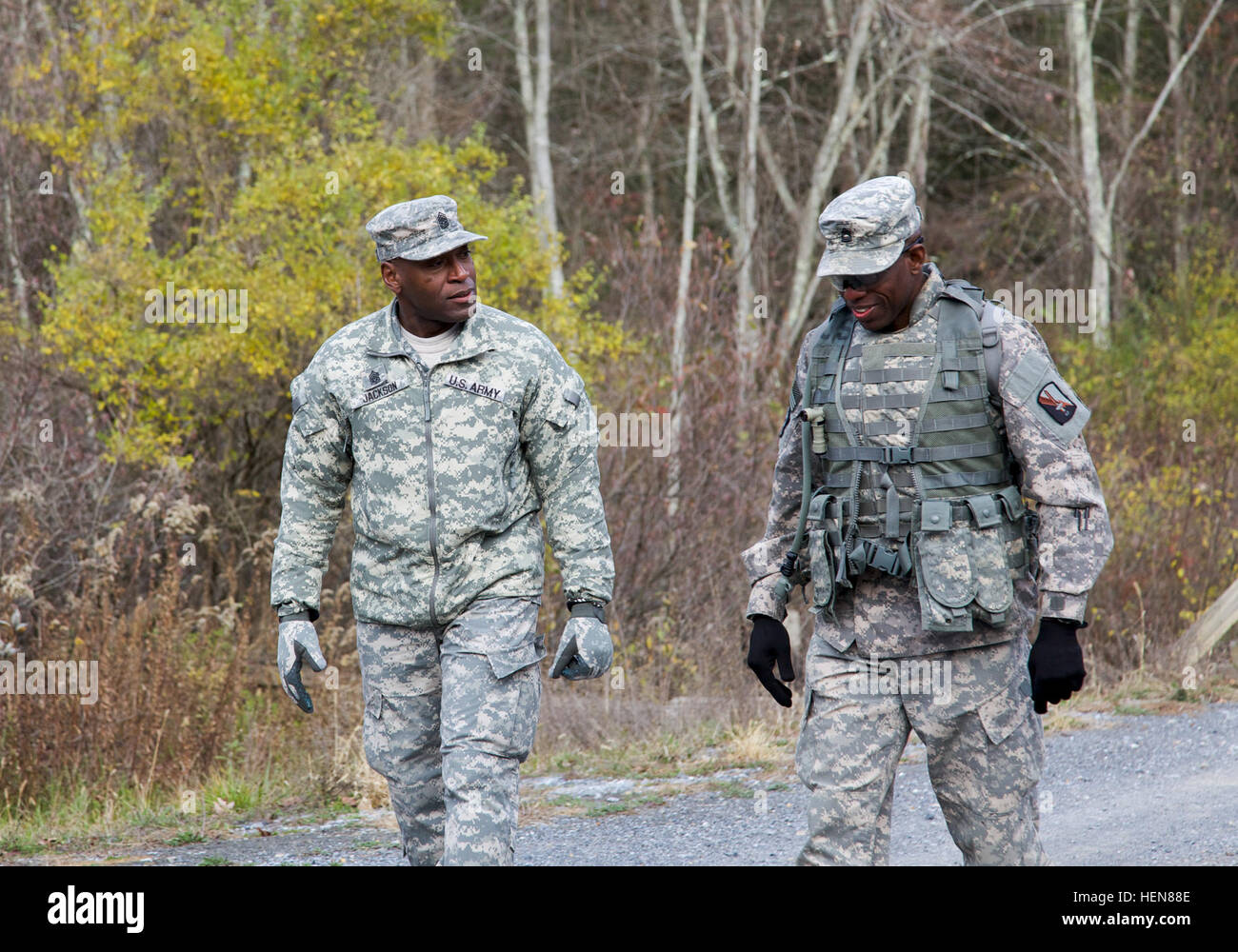 U.S. Army Command Sgt. Maj. James Jackson (left), command sergeant major of 114th Signal Battalion and Sgt. 1st Class Rufus Smith, attached to 55th Signal Company (Combat Camera), walk and talk together during a tactical field training exercise (FTX) at the Ft. Indiantown Gap National Guard Training Center, Annville, Pa., Nov. 5, 2013. The FTX is conducted quarterly to bring soldiers together and practice tactical training from the Army Mission Essential Task List as a battalion. (U.S. Army photo by Sgt. Evangelia Grigiss/Released) 114th Signal Battalion field training exercise 131105-A-LQ527- Stock Photo