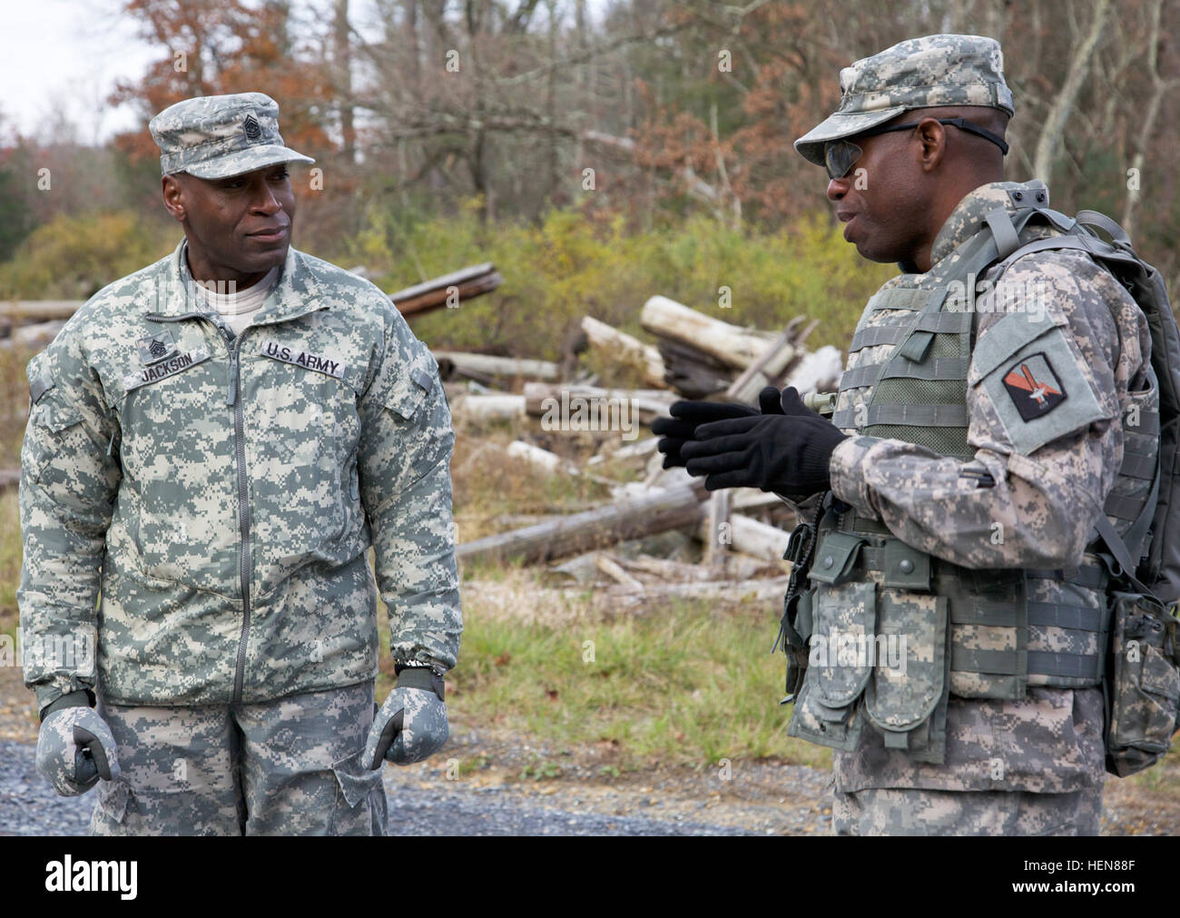 U.S. Army Command Sgt. Maj. James Jackson (left), command sergeant major of 114th Signal Battalion and Sgt. 1st Class Rufus Smith, attached to 55th Signal Company (Combat Camera), talk together during a tactical field training exercise (FTX) at the Ft. Indiantown Gap National Guard Training Center, Annville, Pa., Nov. 5, 2013. The FTX is conducted quarterly to bring soldiers together and practice tactical training from the Army Mission Essential Task List as a battalion. (U.S. Army photo by Sgt. Evangelia Grigiss/Released) 114th Signal Battalion field training exercise 131105-A-LQ527-082 Stock Photo