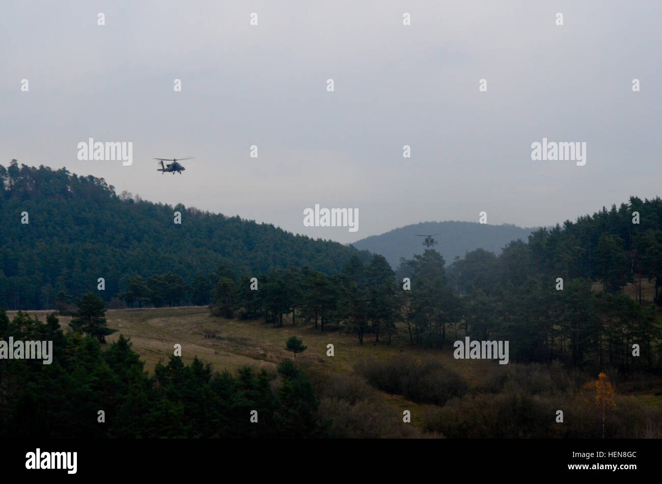 U.S. Army AH-64D Apache attack helicopters assigned to the 2nd Battalion, 159th Aviation Regiment (Attack Reconnaissance) fly over a simulated war zone to provide cover for Czech Land Forces soldiers during exercise Combined Resolve Nov. 11, 2013, at the Joint Multinational Readiness Center in Hohenfels, Germany. Combined Resolve is an annual U.S.-led combined arms exercise designed to prepare U.S. and European forces for multinational operations. (U.S. Army photo by Spc. Justin De Hoyos/Released) U.S. Army AH-64D Apache attack helicopters assigned to the 2nd Battalion, 159th Aviation Regiment Stock Photo