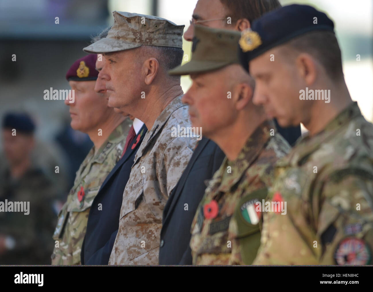 U.S. Marine Corps Gen. Joseph F. Dunford Jr., third from left, commander of International Security Assistance Force and U.S. Forces - Afghanistan, stands next to several senior military and civilian officials as they listen to the invocation during a Remembrance Day ceremony held at ISAF Headquarters in Kabul, Afghanistan, Nov. 11, 2013. The outdoor ceremony consisted of a few readings from the chaplain, a lying of wreaths on the ISAF-Afghan National Security Force monument, and two minutes of silence. Remembrance Day is a memorial day observed in many countries since the end of World War I to Stock Photo