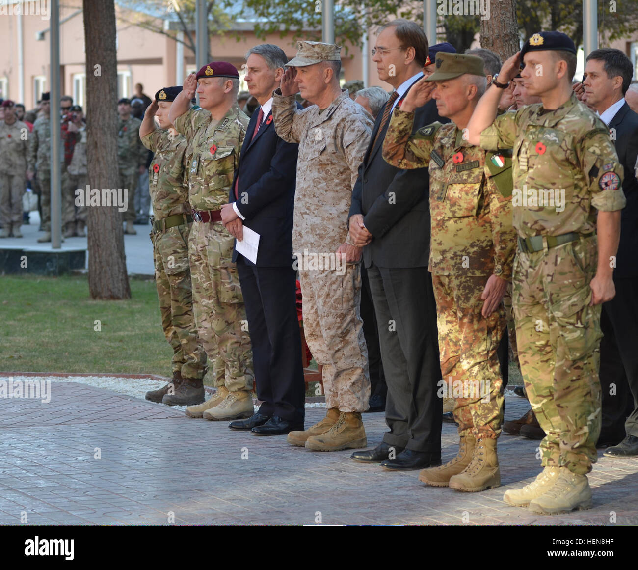 U.S. Marine Corps Gen. Joseph F. Dunford Jr., center, commander of International Security Assistance Force and U.S. Forces - Afghanistan, and several senior military and civilian officials render a salute during a Remembrance Day ceremony held at ISAF Headquarters in Kabul, Afghanistan, Nov. 11, 2013. The outdoor ceremony consisted of a few readings from the chaplain, a lying of wreaths on the ISAF-Afghan National Security Force monument, and two minutes of silence. Remembrance Day is a memorial day observed in many countries since the end of World War I to remember the service members who hav Stock Photo
